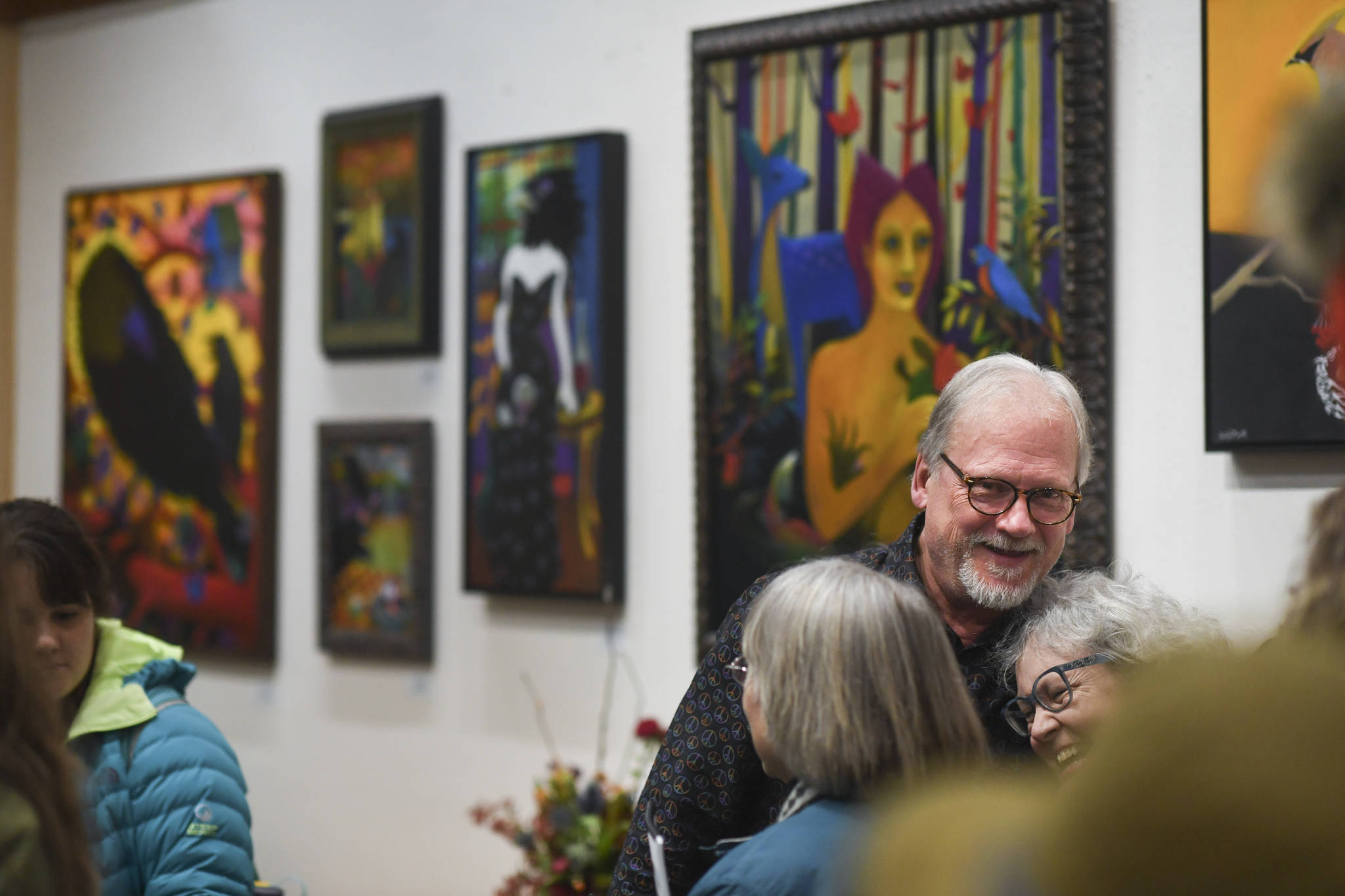 Rick Clair is greeted by friends while showing his latest work at Annie Kaill’s during Gallery Walk on Friday, Dec. 6, 2019. (Michael Penn | Juneau Empire)