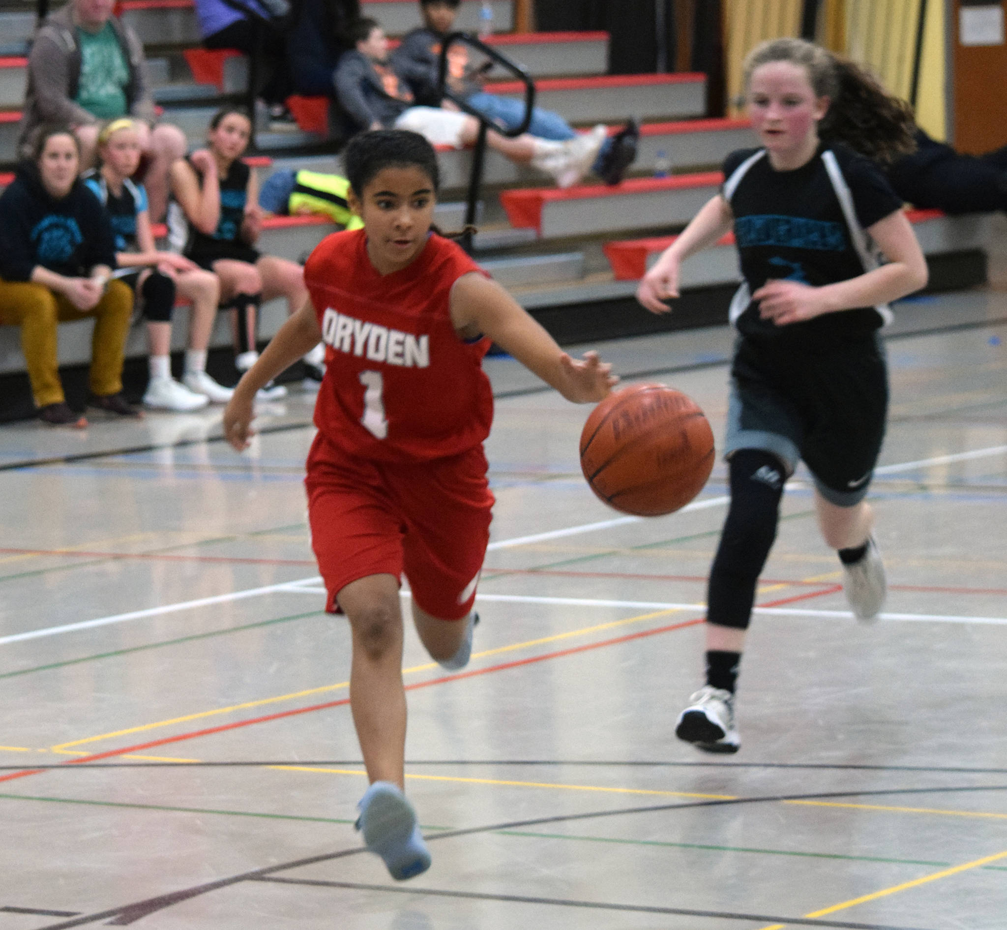 Floyd Dryden’s Jadid Polanco runs down the basketball while Dzantik’i Heeni’s Cambry Lockhart gives chase during a round-robin game at the Icebreaker Tournament at FDMS on Friday, Dec. 6, 2019. (Nolin Ainsworth | Juneau Empire)