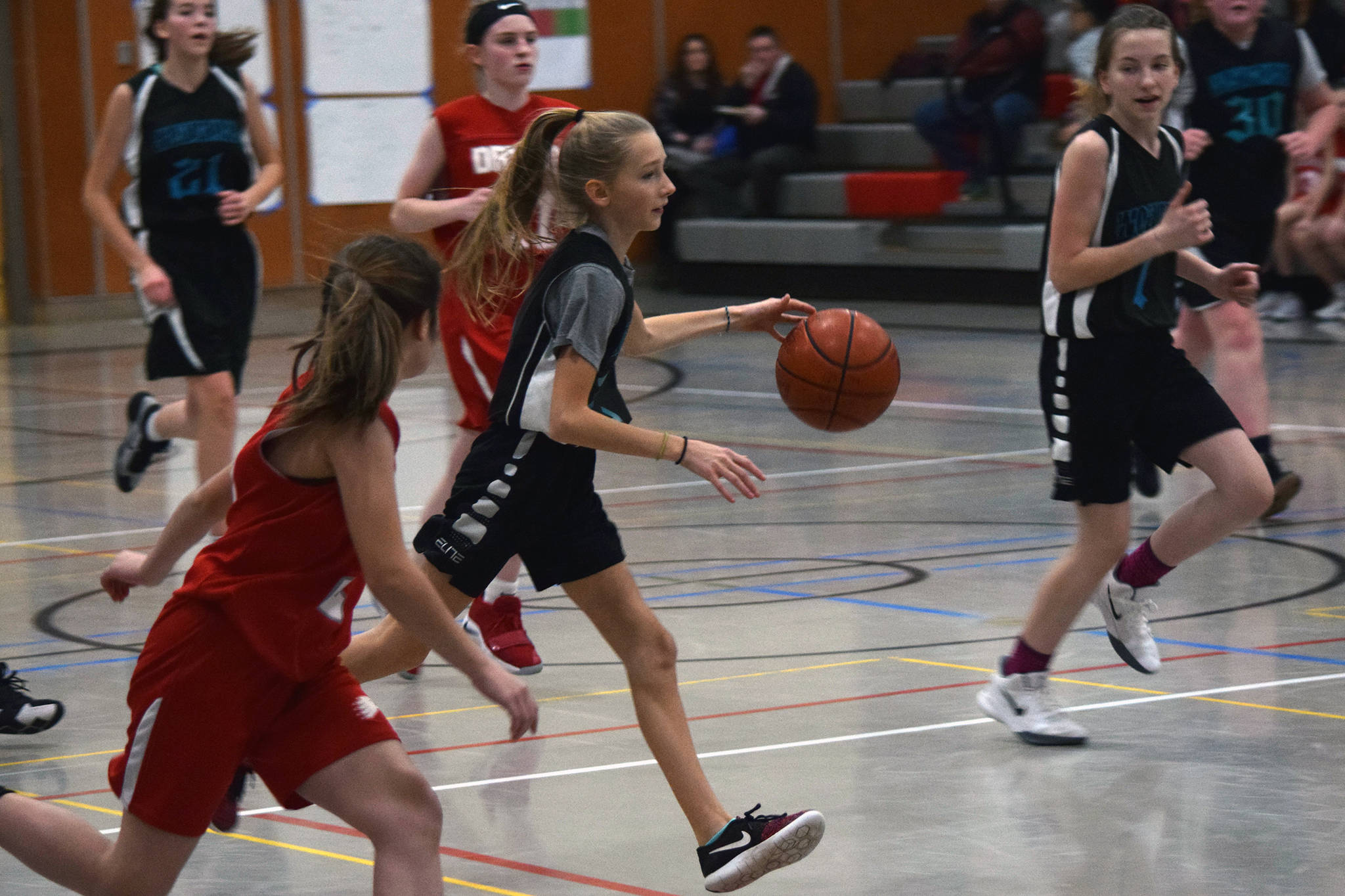 Dzantik’i Heeni’s Rayna Tuckwood pushes the ball as teammate Jenna Dobson, far right, keeps pace during a round-robin game at the Icebreaker Tournament at FDMS on Friday, Dec. 6, 2019. (Nolin Ainsworth | Juneau Empire)