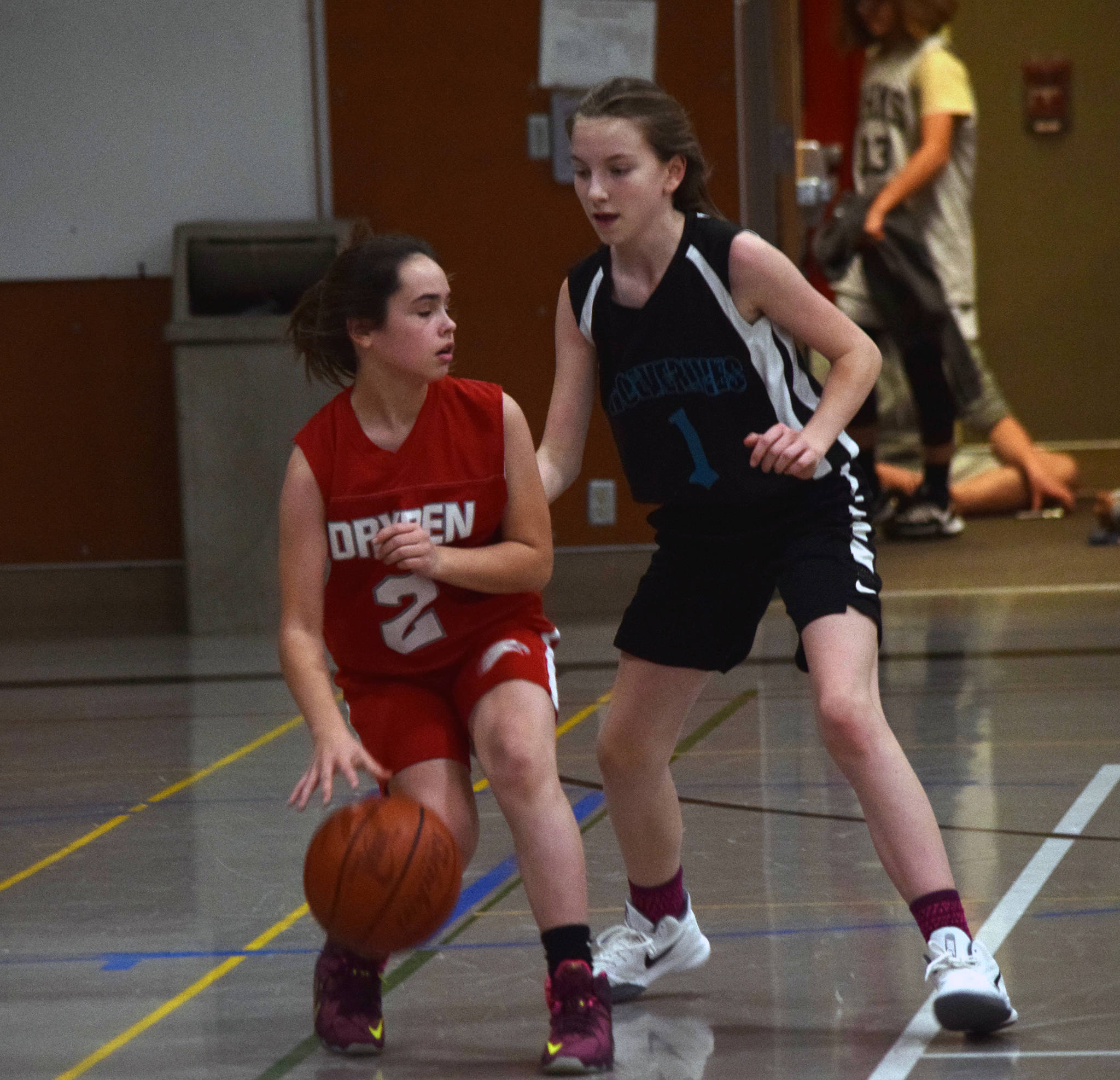 Floyd Dryden’s Jadid Polanco protects the ball as Dzantik’i Heeni’s Jenna Dobson defends during a round-robin game at the Icebreaker Tournament at FDMS on Friday, Dec. 6, 2019. (Nolin Ainsworth | Juneau Empire)