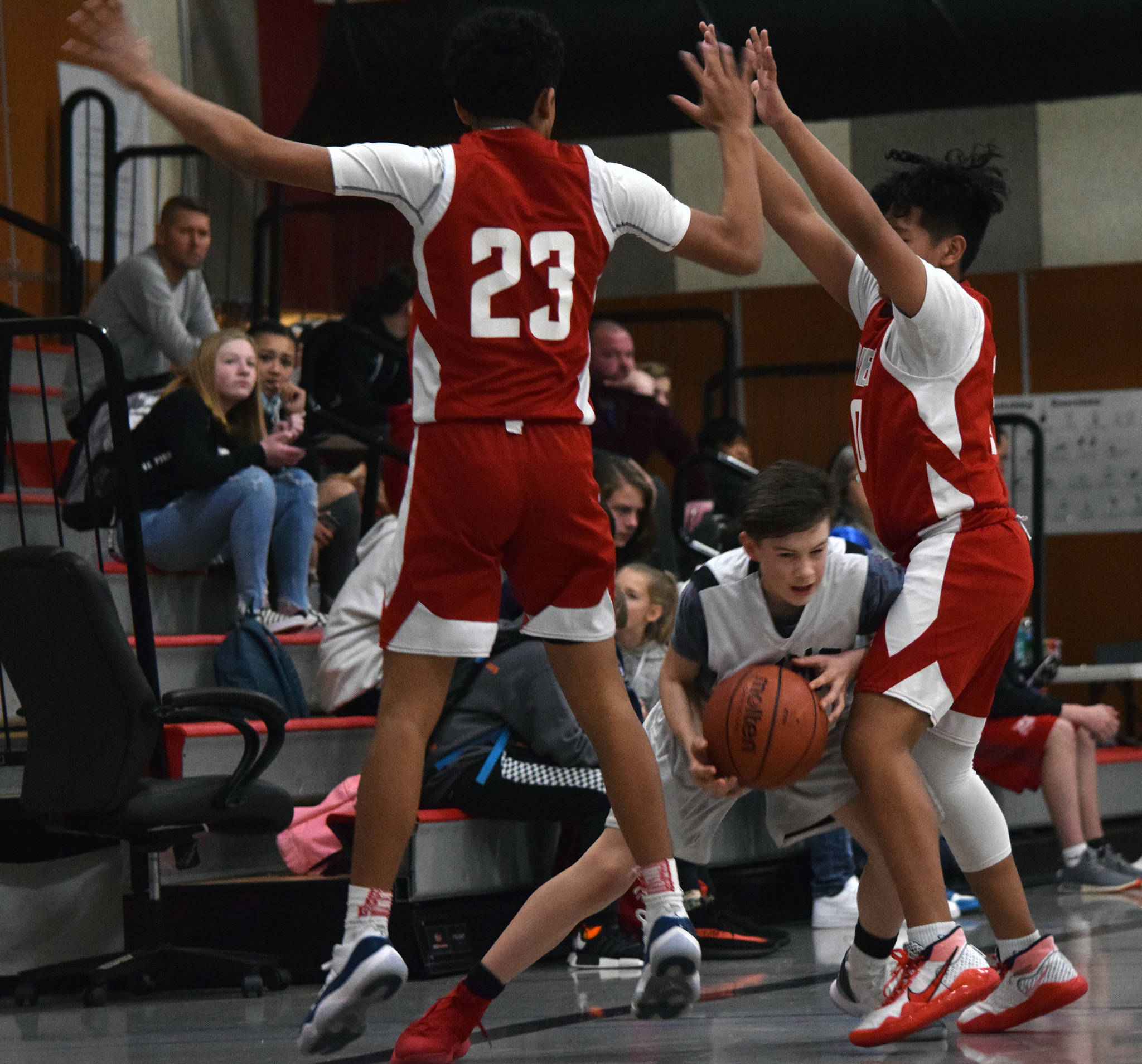 Dzantik’i Heeni’s Sam Lockhart is stopped near half court by Floyd Dryden’s Antone Araujo, left, and Lance Nierra during a round-robin game at the Icebreaker Tournament at FDMS on Friday, Dec. 6, 2019. (Nolin Ainsworth | Juneau Empire)