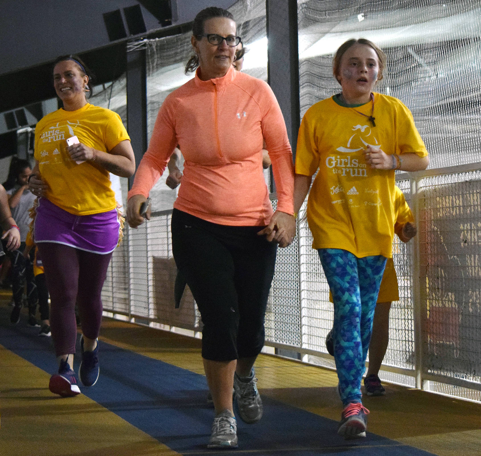 Emily Wall, left, runs alonside her daughter, 10-year-old Ellie Jo, during the Girls on the Run/Boys Run I toowú klatseen 5K at the Dimond Park Field House on Saturday, Dec. 7, 2019. Approximately 80 kids from the two programs participated in the event. (Nolin Ainsworth | Juneau Empire)