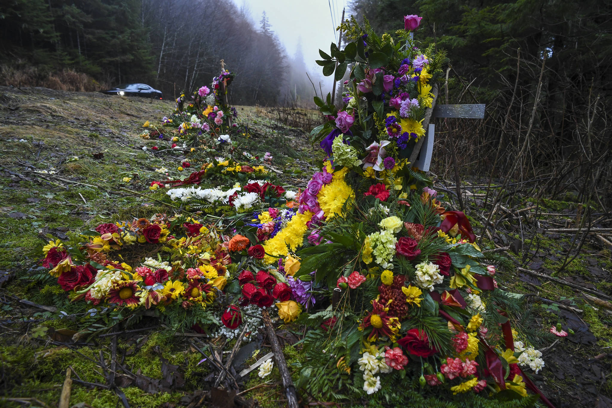 Two crosses ladened with flowers memorialize a 19-year-old woman and a 15-year-old boy who were killed in an vehicle accident near Mile 20 on Glacier Highway on Nov. 21. Two others were injured. (Michael Penn | Juneau Empire)
