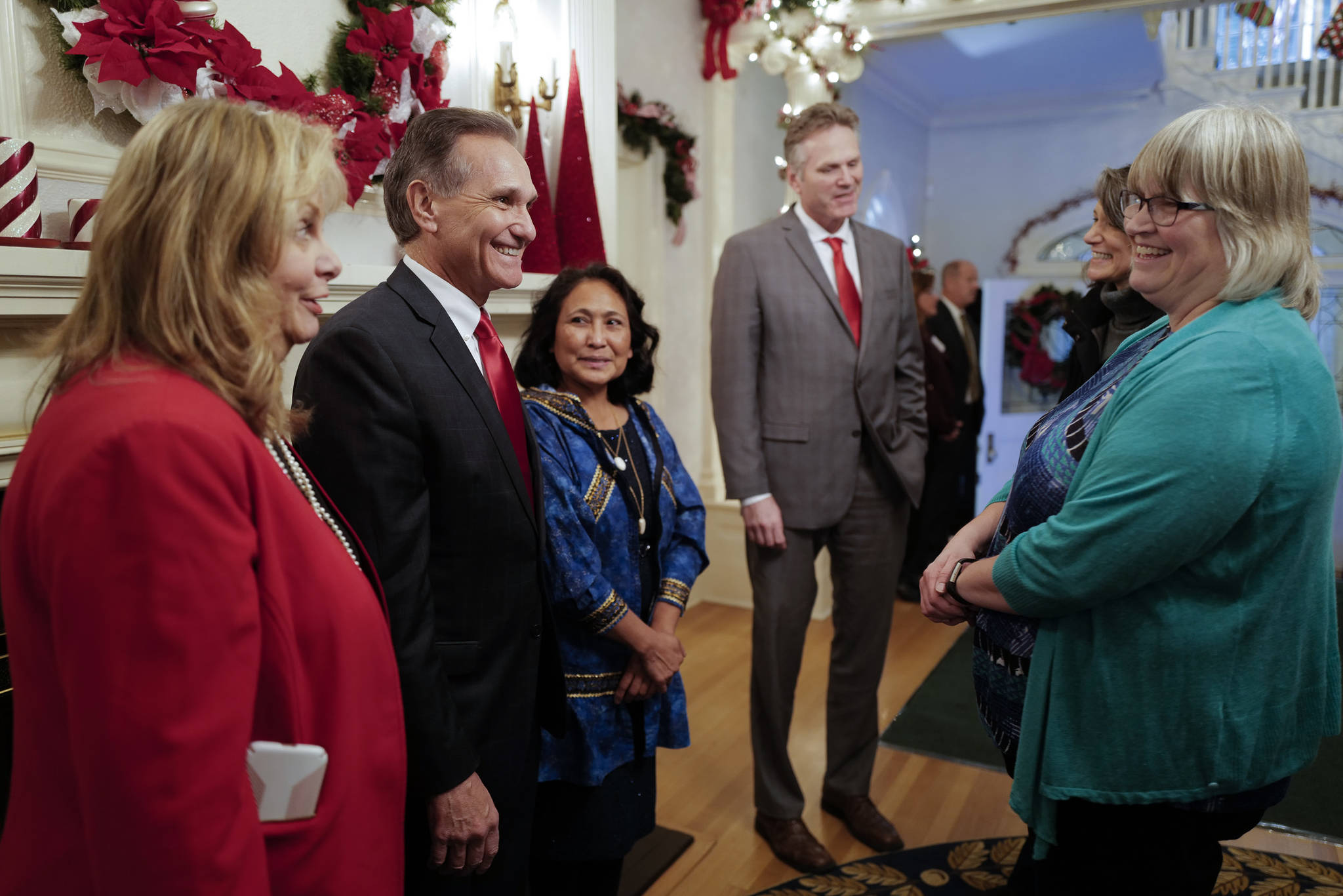 Juneau Mayor Beth Weldon, right, is greeted by Gov. Mike Dunleavy, R-Alaska, and his wife, Rose, Lt. Gov. Kevin Meyer and his wife, Marti, at the Governor’s Open House on Tuesday, Dec. 10, 2019. (Michael Penn | Juneau Empire)
