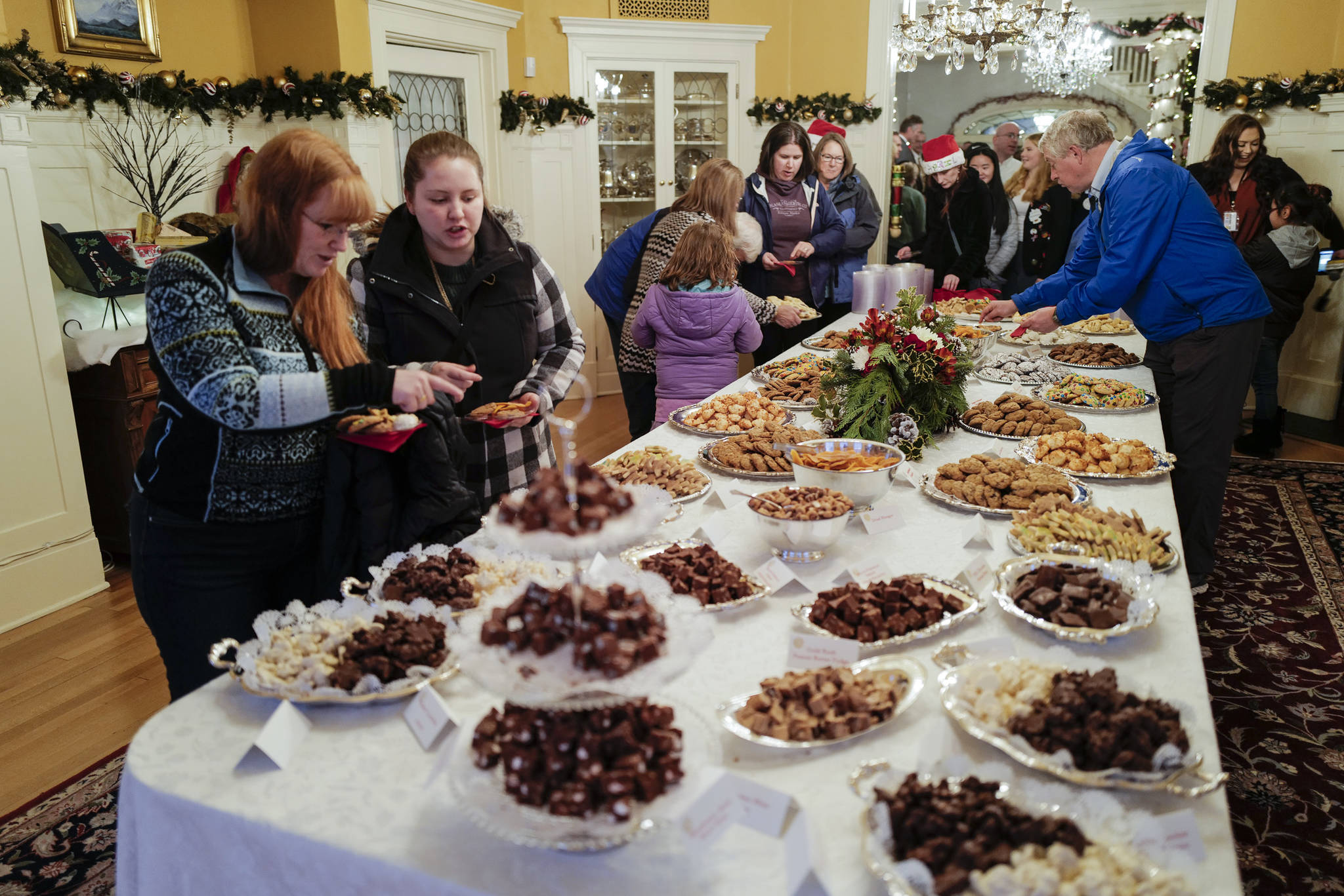 Juneau residents choose their cookies at the Governor’s Open House on Tuesday, Dec. 10, 2019. (Michael Penn | Juneau Empire)