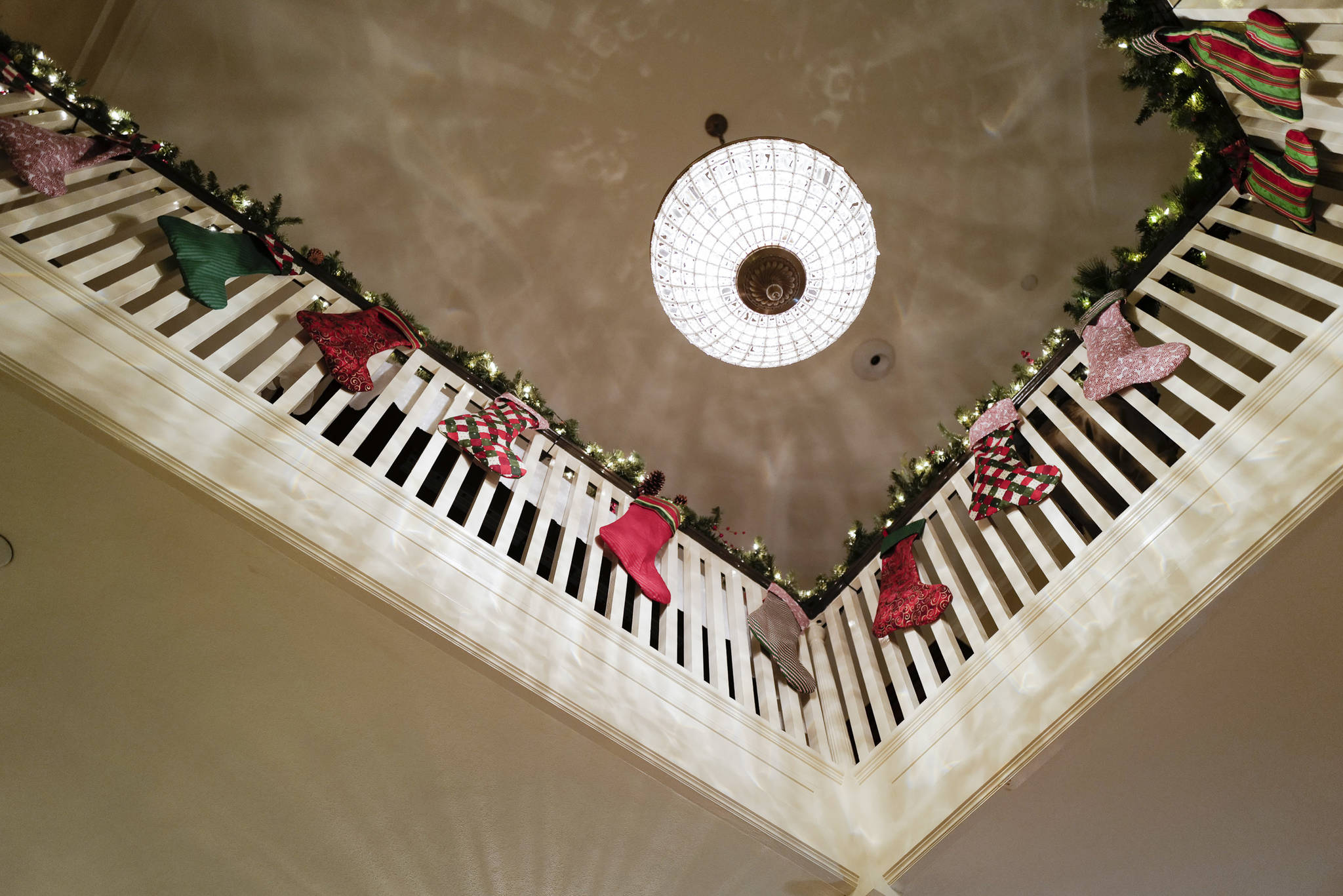 Stockings hang decorate the second floor balcony during the Governor’s Open House on Tuesday, Dec. 10, 2019. (Michael Penn | Juneau Empire)