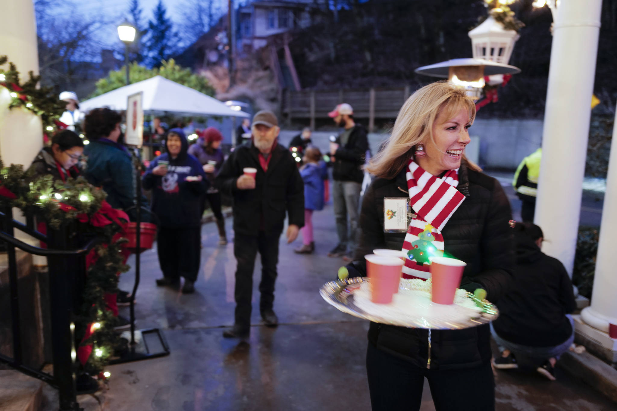 Amanda Price, Commissioner of the Department of Public Safety, serves hot cider outside during the Governor’s Open House on Tuesday, Dec. 10, 2019. (Michael Penn | Juneau Empire)
