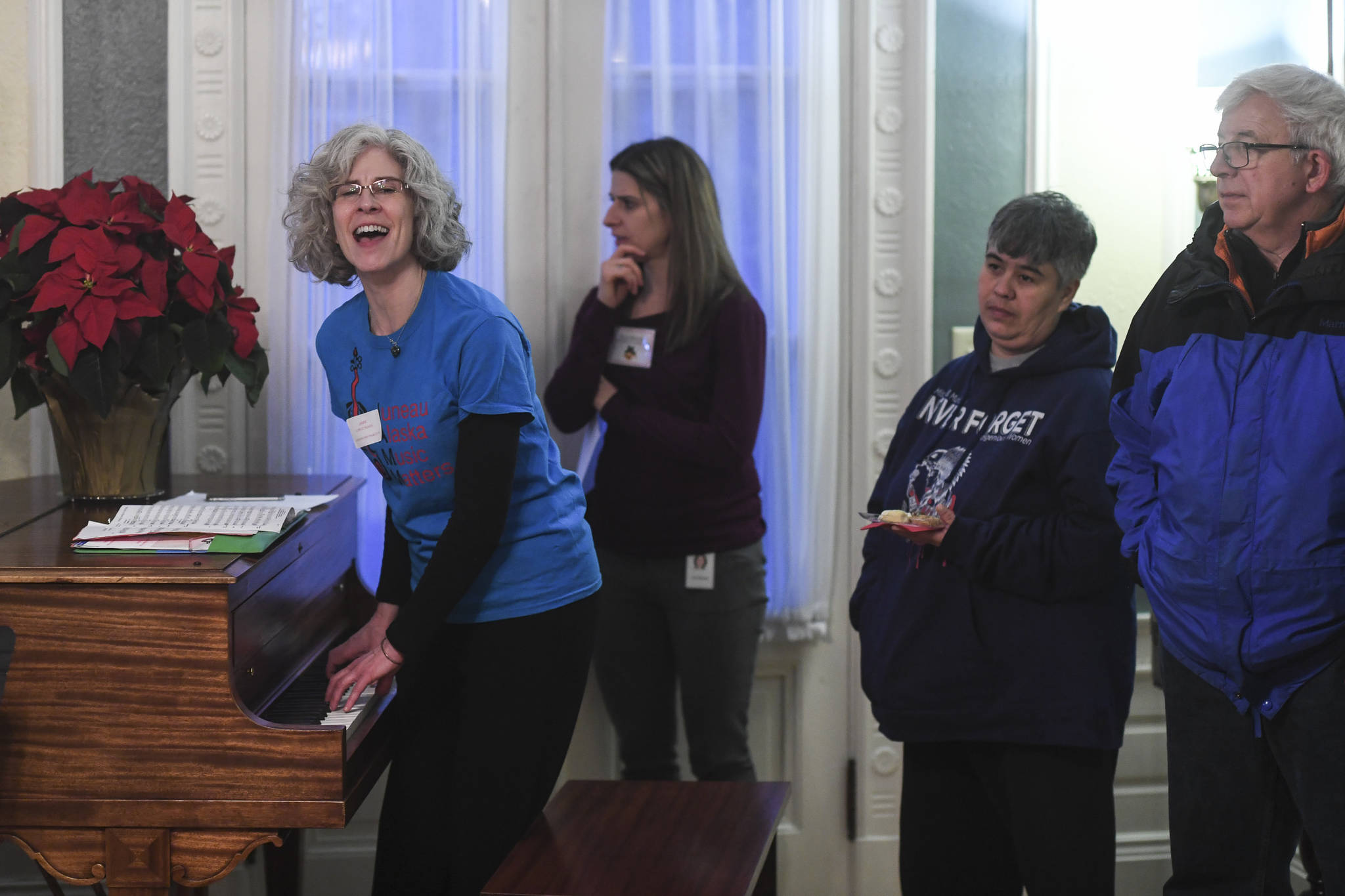 Lorrie Heagy, Executive Director of JAMM and the music teacher at Glacier Valley, sings with the students during the Governor’s Open House on Tuesday, Dec. 10, 2019. (Michael Penn | Juneau Empire)