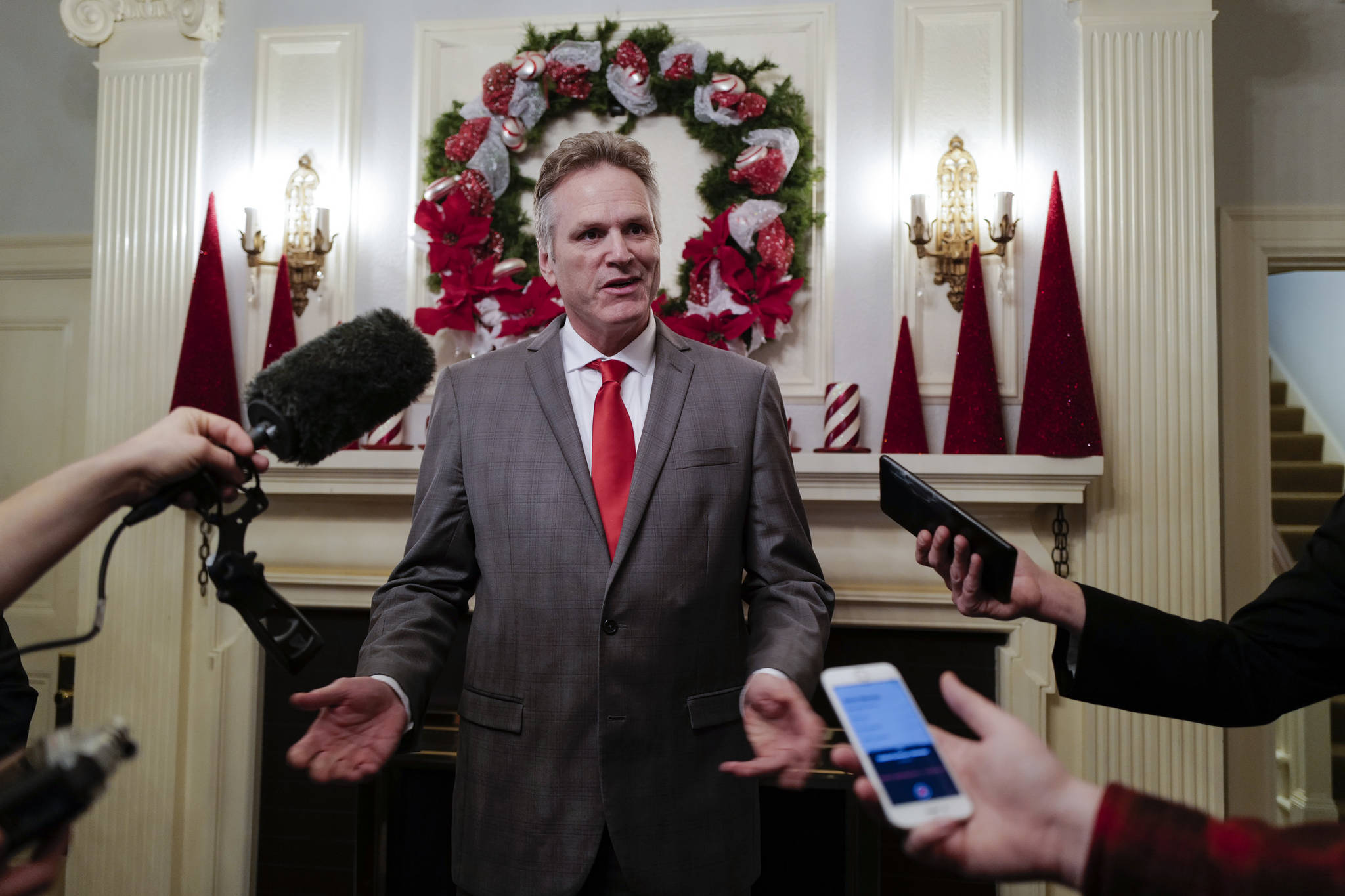 Gov. Mike Dunleavy, R-Alaska, speaks to members of the media before the Governor’s Open House on Tuesday, Dec. 10, 2019. (Michael Penn | Juneau Empire)
