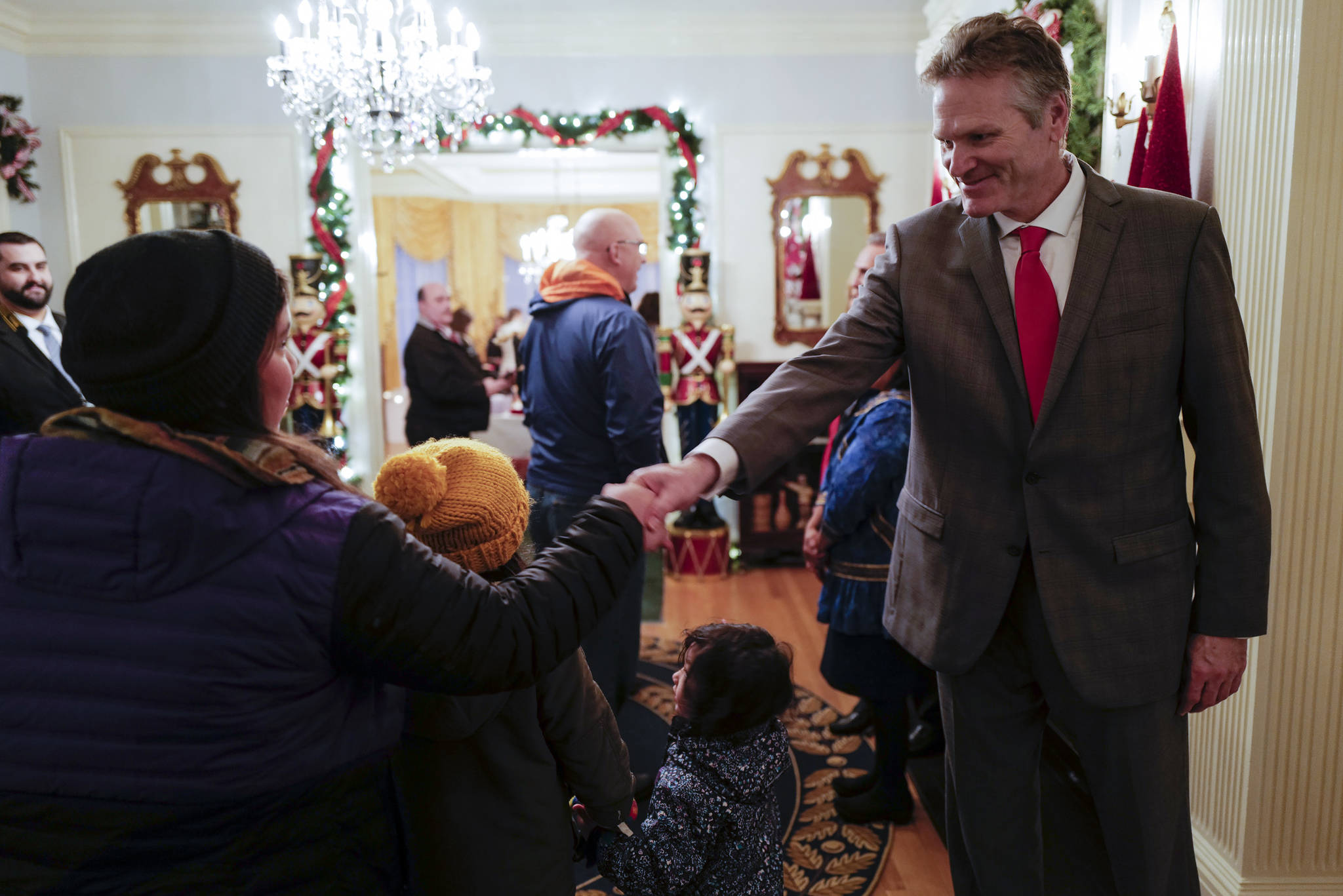 Gov. Mike Dunleavy, R-Alaska, greets Juneau residents at the Governor’s Open House on Tuesday, Dec. 10, 2019. (Michael Penn | Juneau Empire)