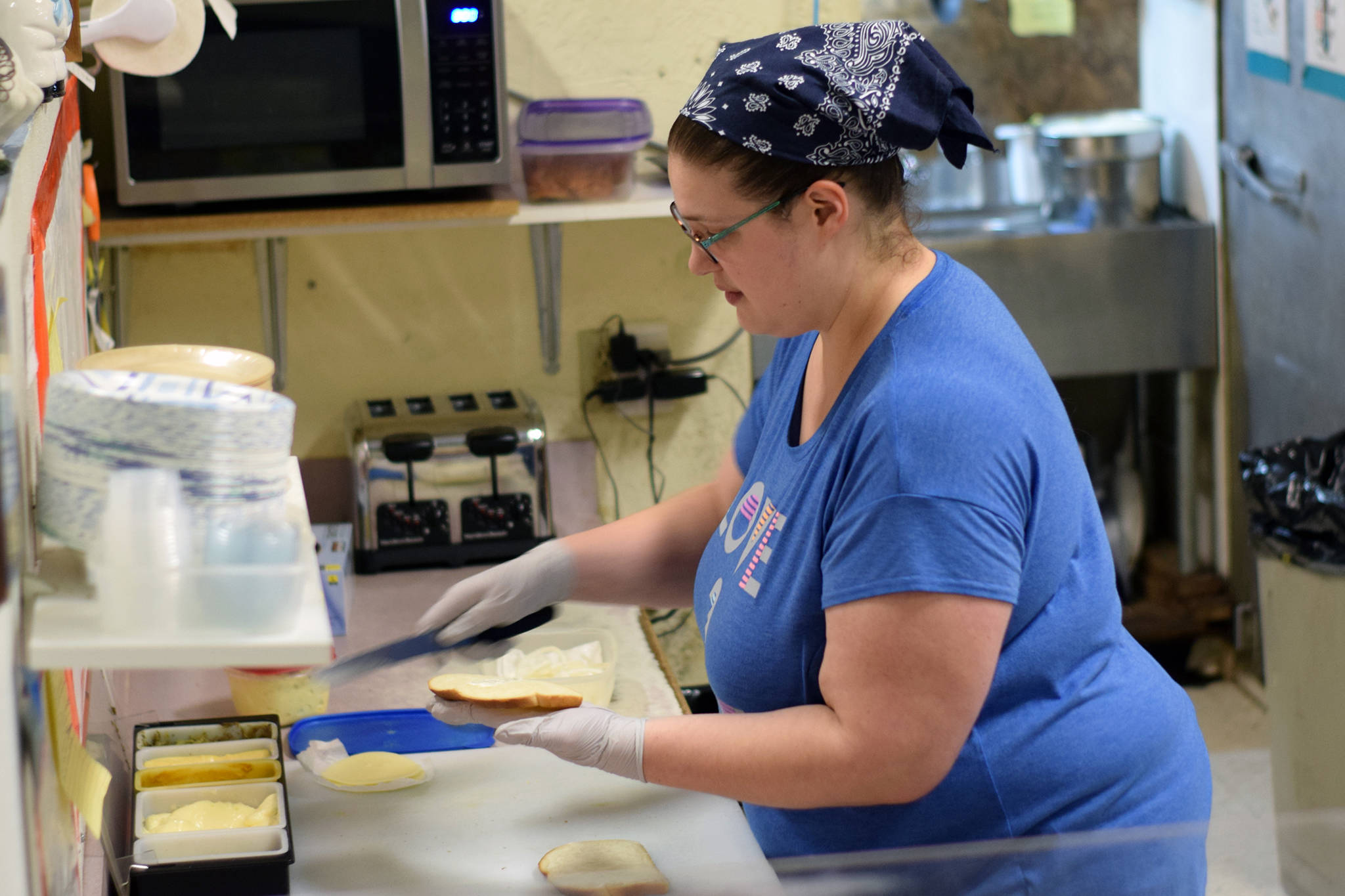 Udder Culture featuring Aurora Sweets employee Karlin Davis makes a sandwich on Dec. 10, 2019. Davis has worked at the sandwich shop since 2008. (Nolin Ainsworth | Juneau Empire)