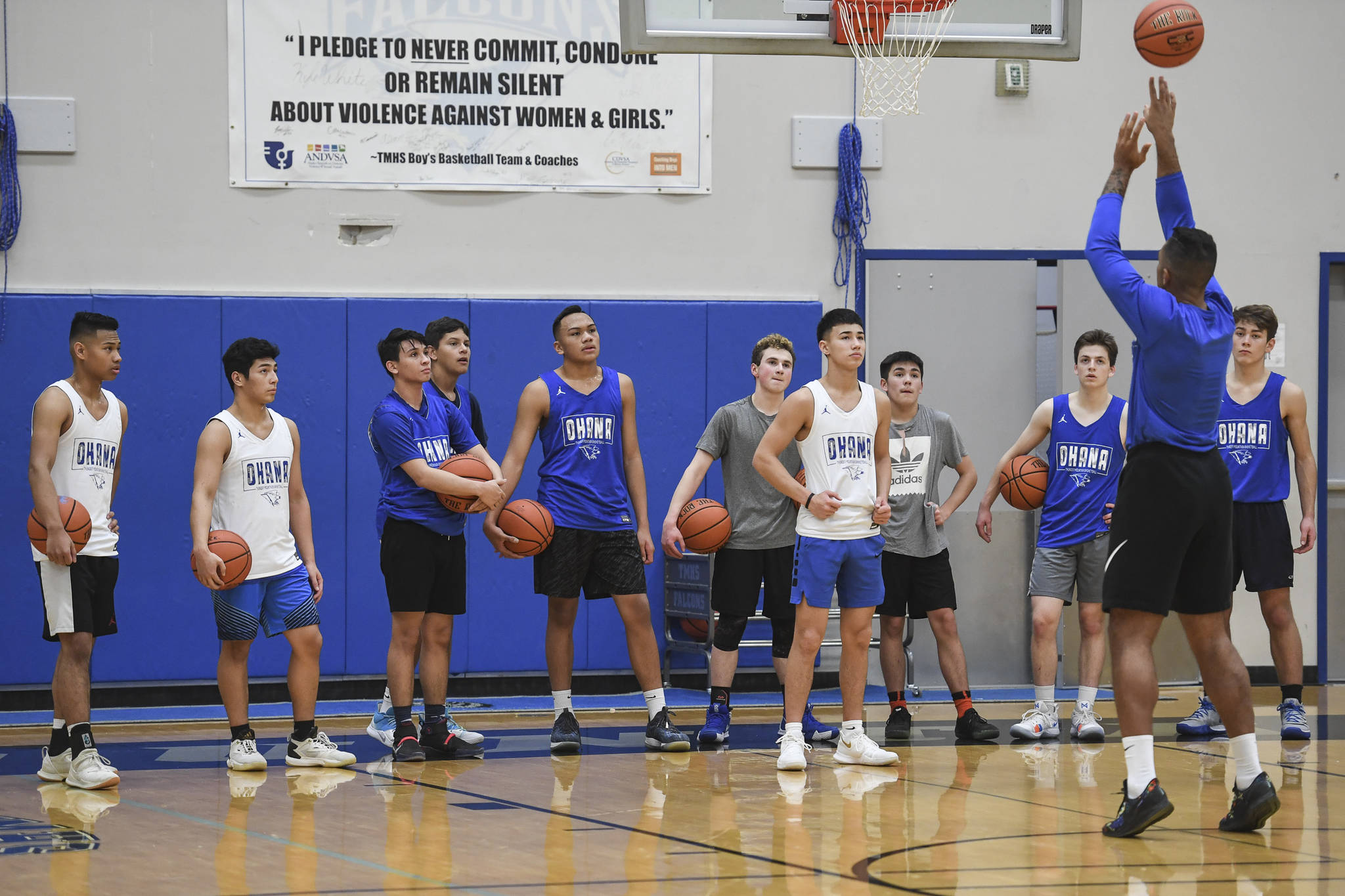 Former professional basketball player Damen Bell-Holter gives a shooting lesson during boys varsity basketball practice at Thunder Mountain High School on Tuesday, Dec. 10, 2019. (Michael Penn | Juneau Empire)