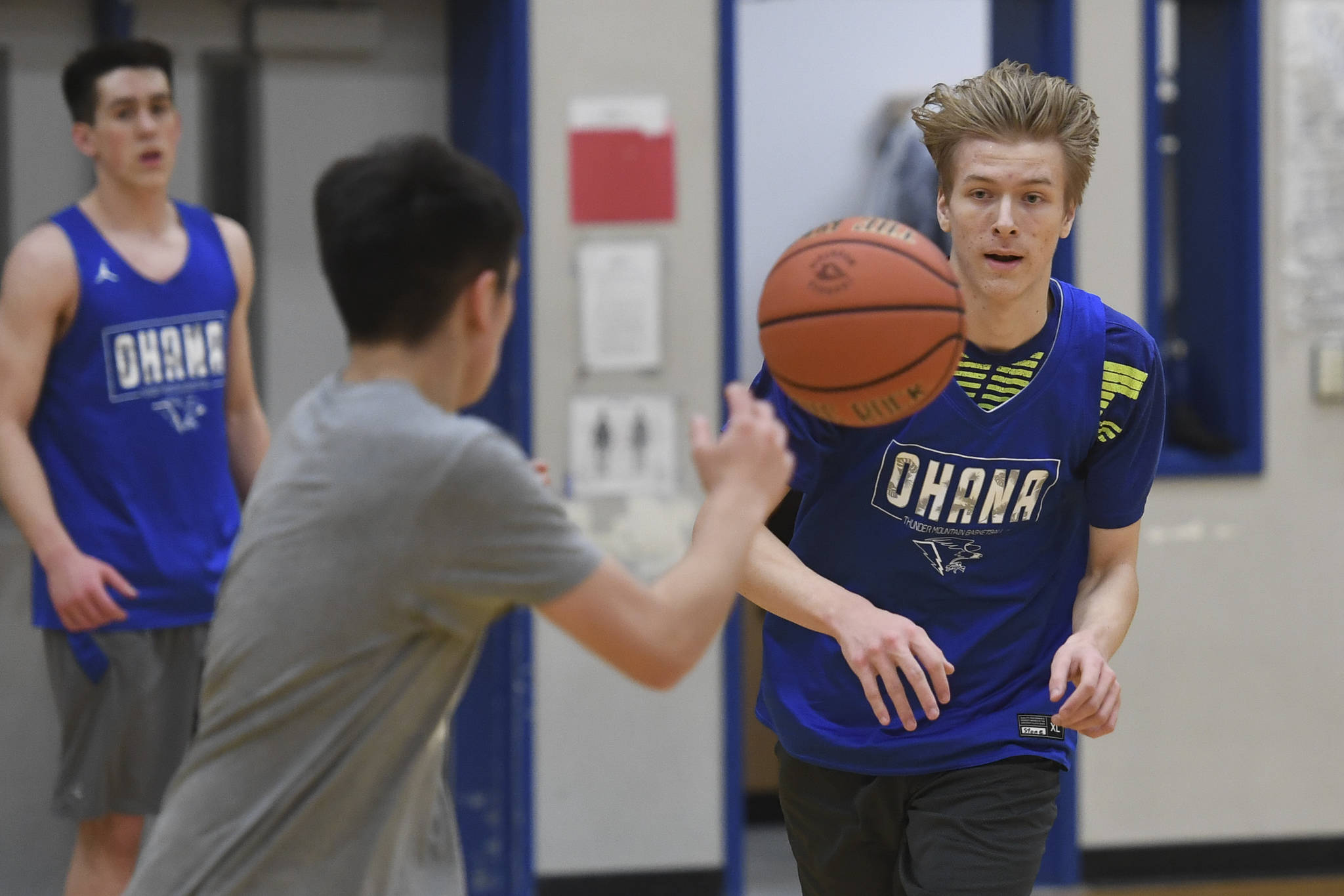 Stone Morgan, right, makes a pass during boys varsity basketball practice at Thunder Mountain High School on Tuesday, Dec. 10, 2019. (Michael Penn | Juneau Empire)