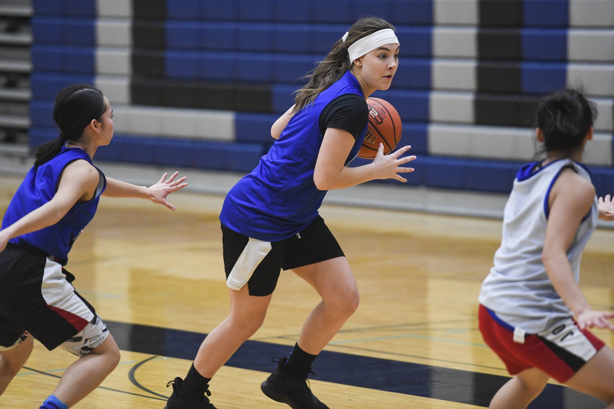 Avery Kreischer, center, is guarded by Mary Neal Garcia, left, and Mary Khaye Garcia during girls varsity basketball practice at Thunder Mountain High School on Monday, Dec. 9, 2019. (Michael Penn | Juneau Empire)