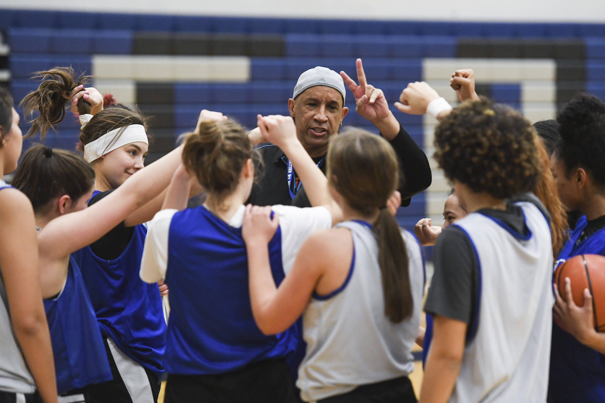 Coach Andy Lee gives starts off a cheer during the girls varsity basketball practice at Thunder Mountain High School on Monday, Dec. 9, 2019. (Michael Penn | Juneau Empire)
