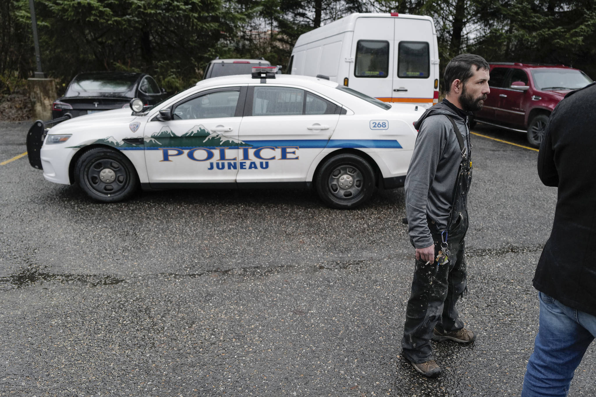 Bill Peters waits near a police cruiser at the Department of Transportation and Public Facilities Buildig on Channel Drive on Wednesday, Dec. 11, 2019. Police found Peters’ stolen vehicle parked in the department’s lot. (Michael Penn | Juneau Empire)