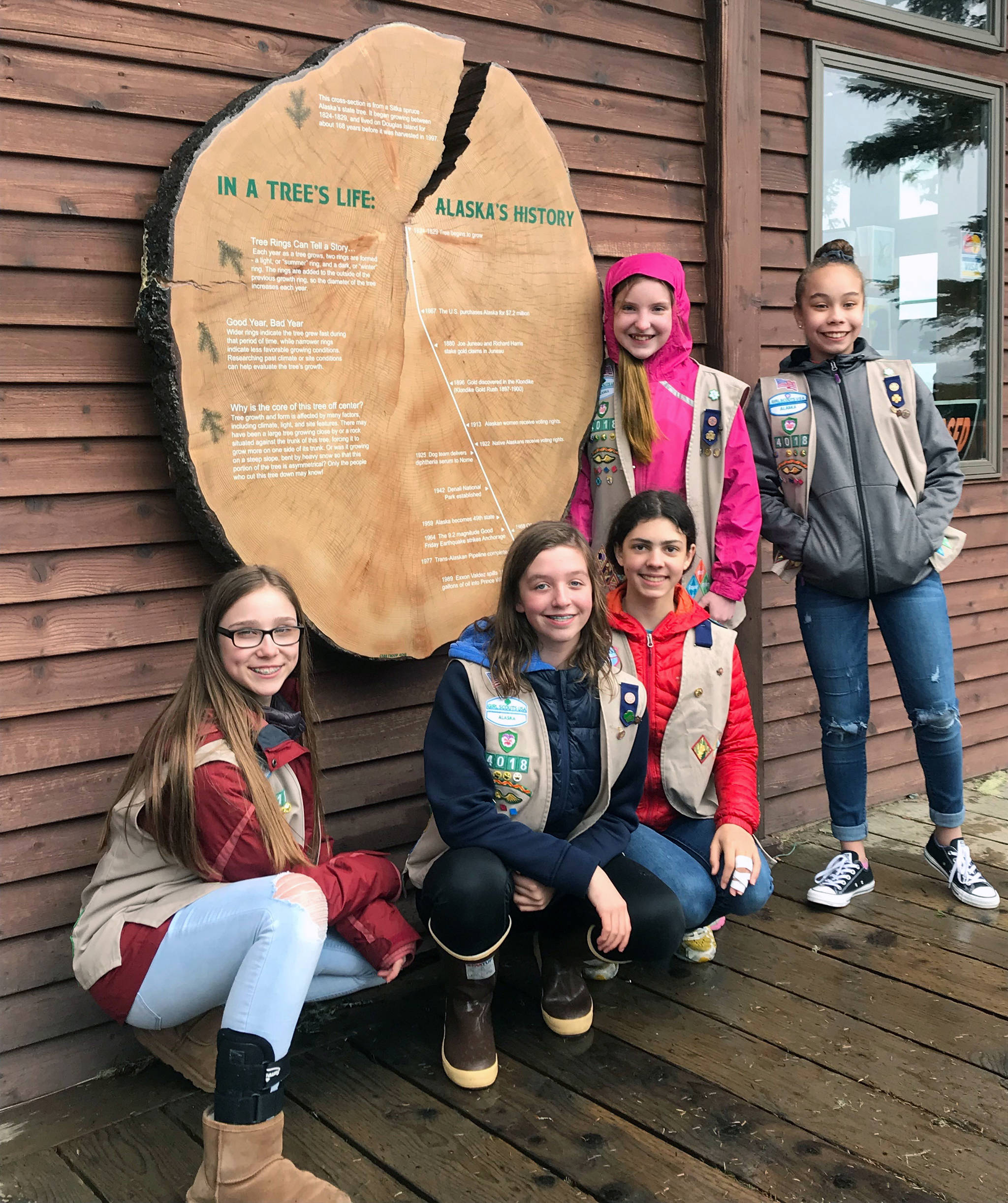 Girl Scout troop 4018 members Jayden Rosenbruch, Lauren Stichert, Anita Morrison, Sophia Owen and Sophia Ludeman pose with their display just after it was installed at The Nature Center last April. (Courtesy photo)