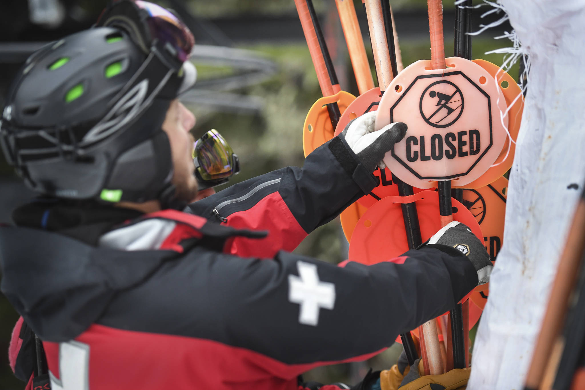 Ski Patroller Calder Otsea takes apart bamboo hazard markers at Eaglecrest Ski Area on Thursday, Dec. 12, 2019. (Michael Penn | Juneau Empire)
