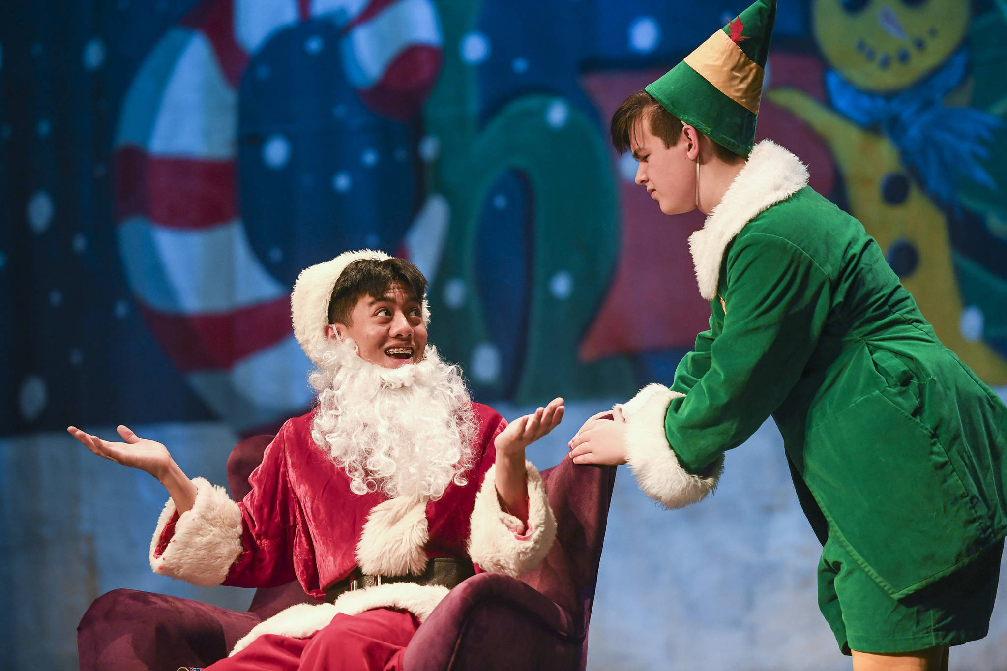 Fake Santa, played by Richard Corpuz, left, and Buddy the Elf, played by Toby Russell, rehearse in “Elf the Musicial” at Juneau-Douglas High School: Yadaa.at Kalé on Friday, Dec. 13, 2019. (Michael Penn | Juneau Empire)