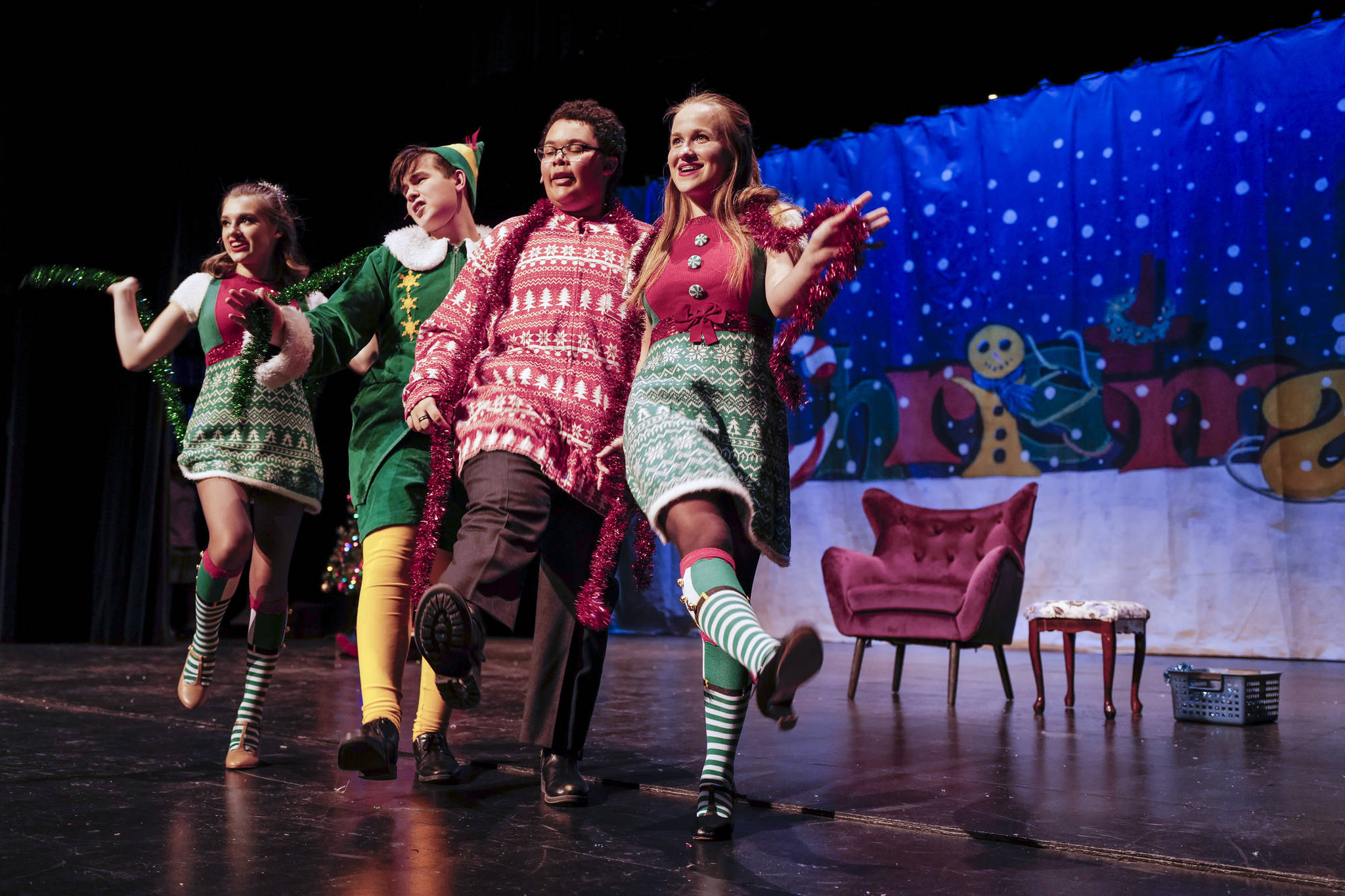Kayla Kohlhase, left, Toby Russell, Roman Mahanyu, Shelby Yor, right, rehearse “Elf the Musicial” at Juneau-Douglas High School: Yadaa.at Kalé on Friday, Dec. 13, 2019. (Michael Penn | Juneau Empire)