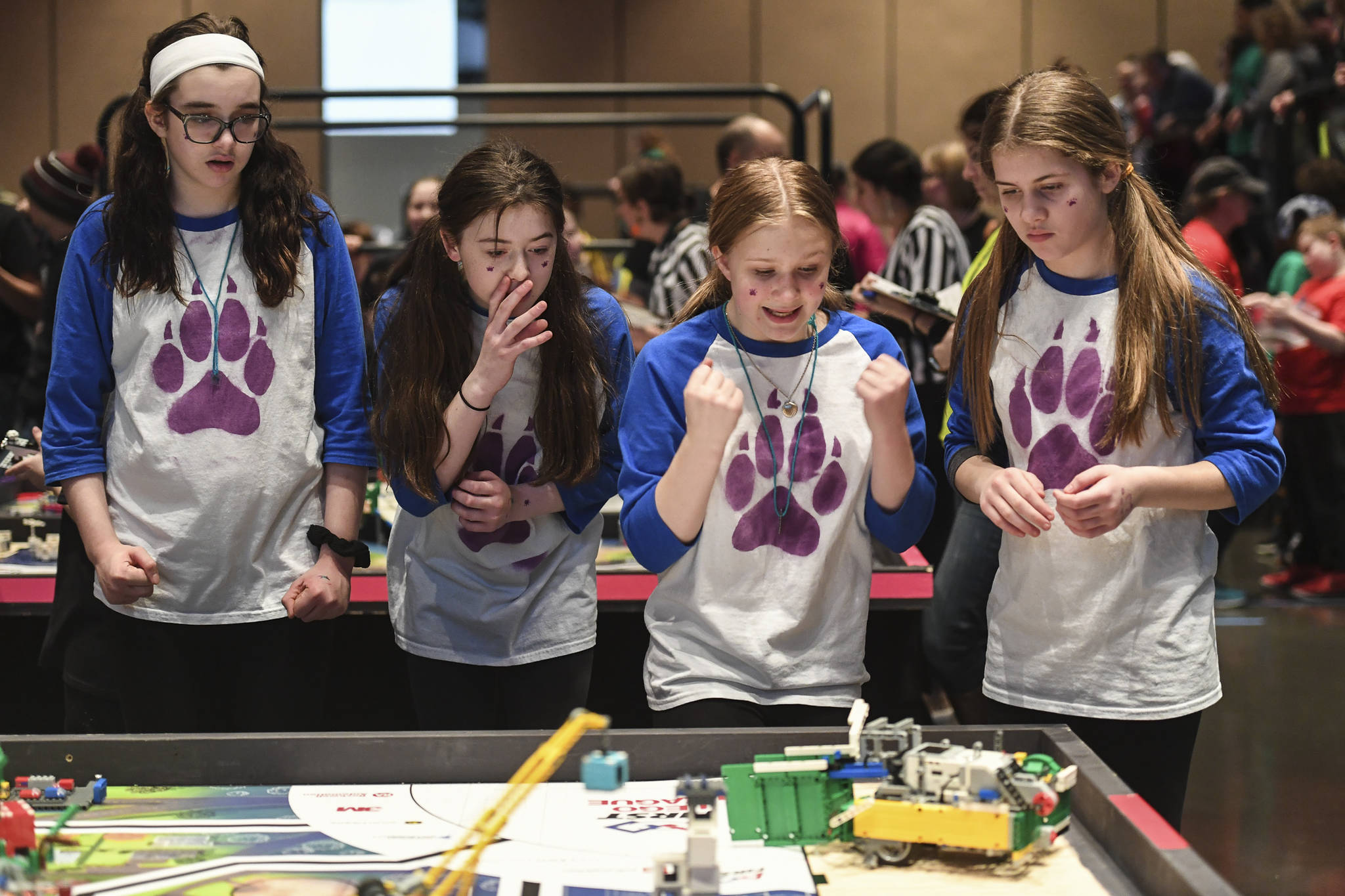 Members of the Tundra Wolves, Rosina Wolfenberger, left, Jerralyn White, Eva Miller and Kennedy White, right, cheer on their robot as they complete in the First Lego League Challenge during the Juneau Robot Jamboree at Centennial Hall on Saturday, Dec. 14, 2019. Twenty teams, two remotely, competed in the First Lego League and four more in the Junior League. the robot performance is one of four parts to the contest. The students are also graded on teamwork, a research project and robot design. Top teams will earn entry to the Alaska State Championship on Feb. 7-8, 2020, at Colony High School. (Michael Penn | Juneau Empire)
