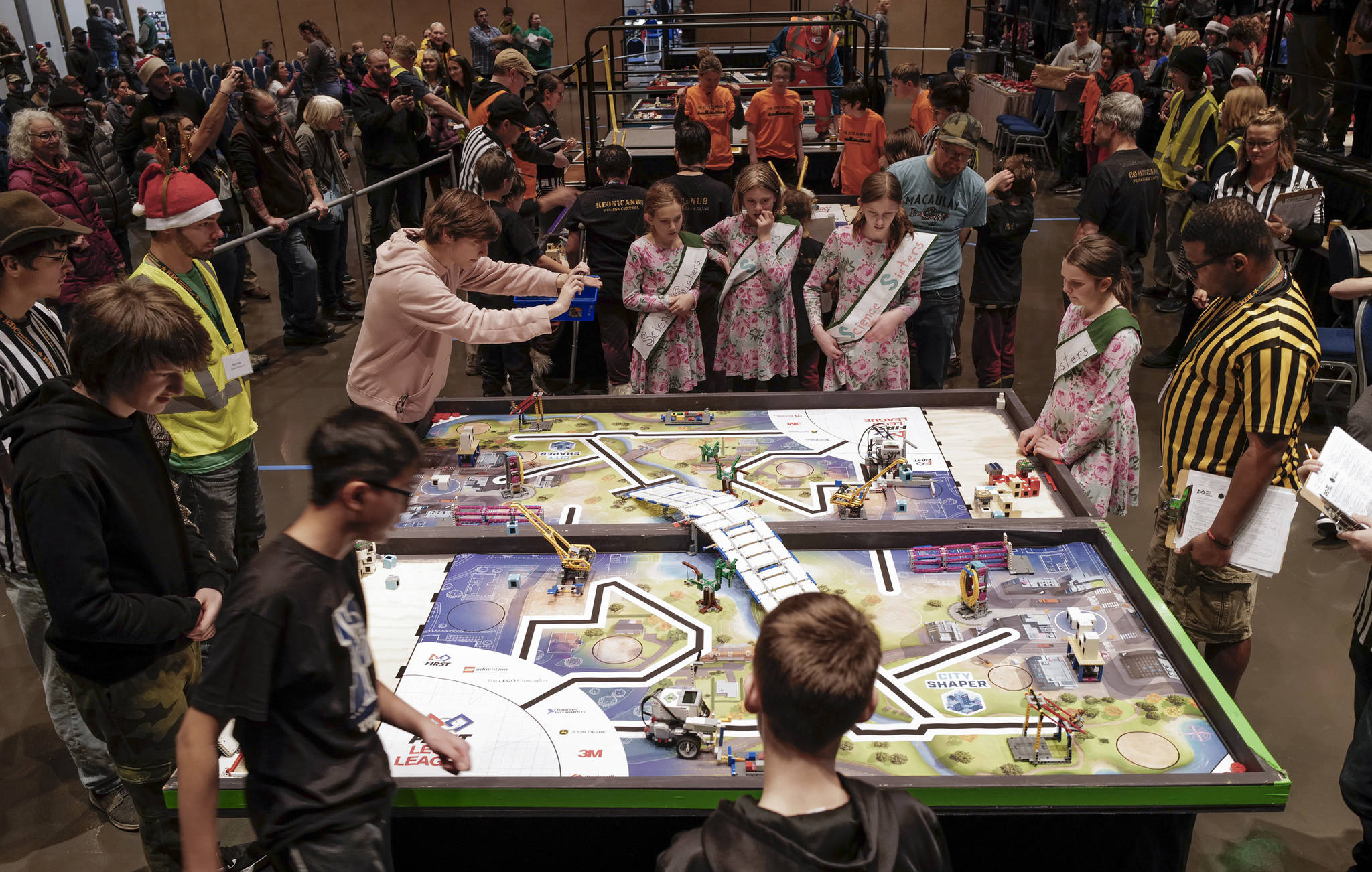 The Petersburg Vikings, below, and Science Sisters teams watch their robots complete in the First Lego League Challenge during the Juneau Robot Jamboree at Centennial Hall on Saturday, Dec. 14, 2019. Twenty teams, two remotely, competed in the First Lego League and four more in the Junior League. the robot performance is one of four parts to the contest. The students are also graded on teamwork, a research project and robot design. Top teams will earn entry to the Alaska State Championship on Feb. 7-8, 2020, at Colony High School. (Michael Penn | Juneau Empire)