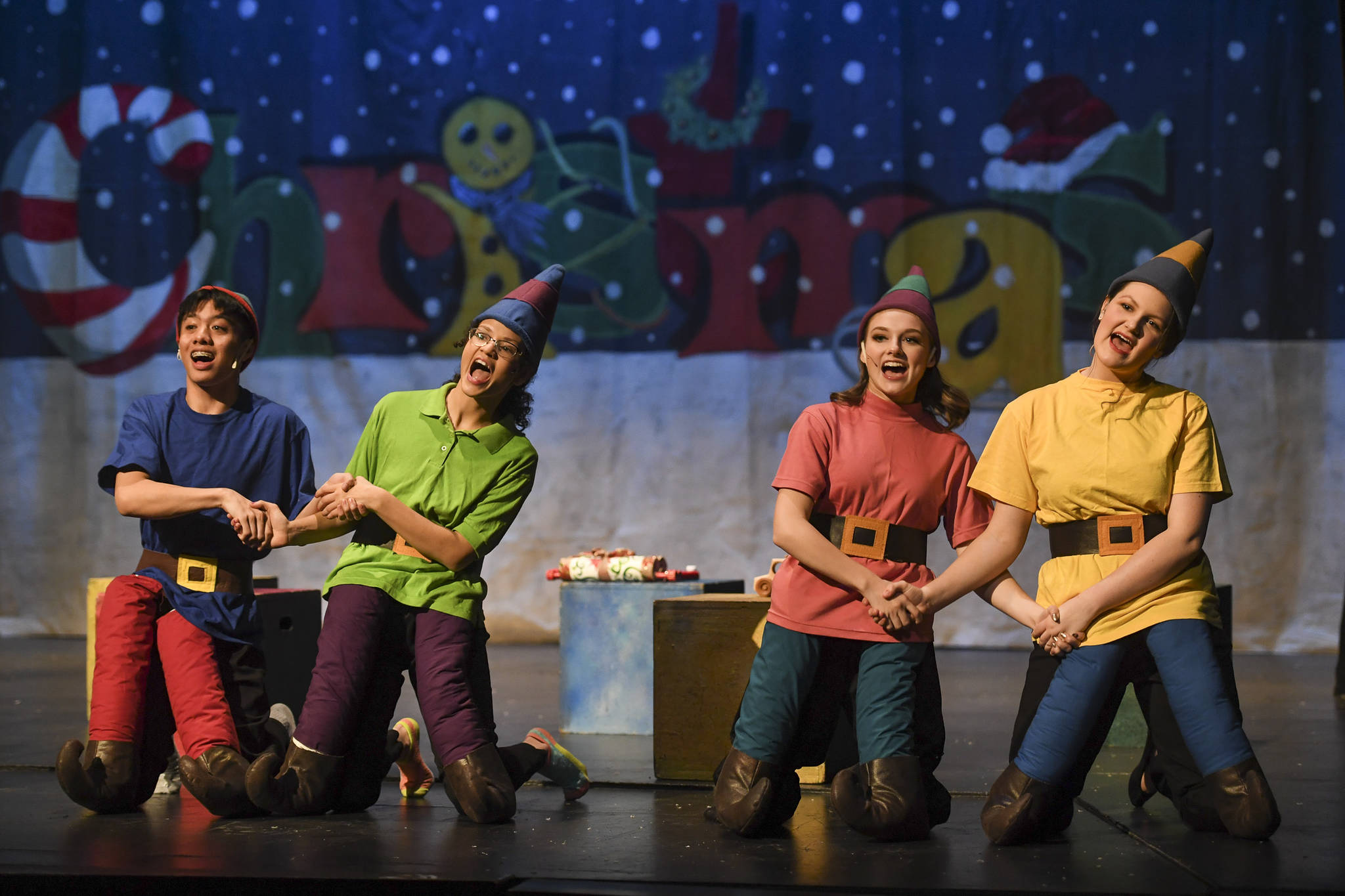 Richard Corpuz, left, Maya John-Beavers, Kayla Kohlhase, Amanda McDowell rehearse “Elf, the Musicial” at Juneau-Douglas High School: Yadaa.at Kalé on Friday, Dec. 13, 2019. (Michael Penn | Juneau Empire)