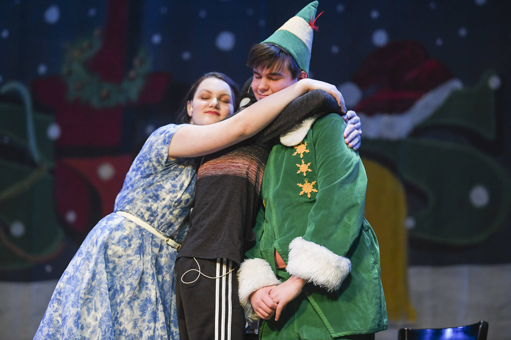 Amanda McDowell, left, Cahal Burnham and Toby Russell play the Hobbs family during the rehearsal of “Elf, the Musicial” at Juneau-Douglas High School: Yadaa.at Kalé on Friday, Dec. 13, 2019. (Michael Penn | Juneau Empire)