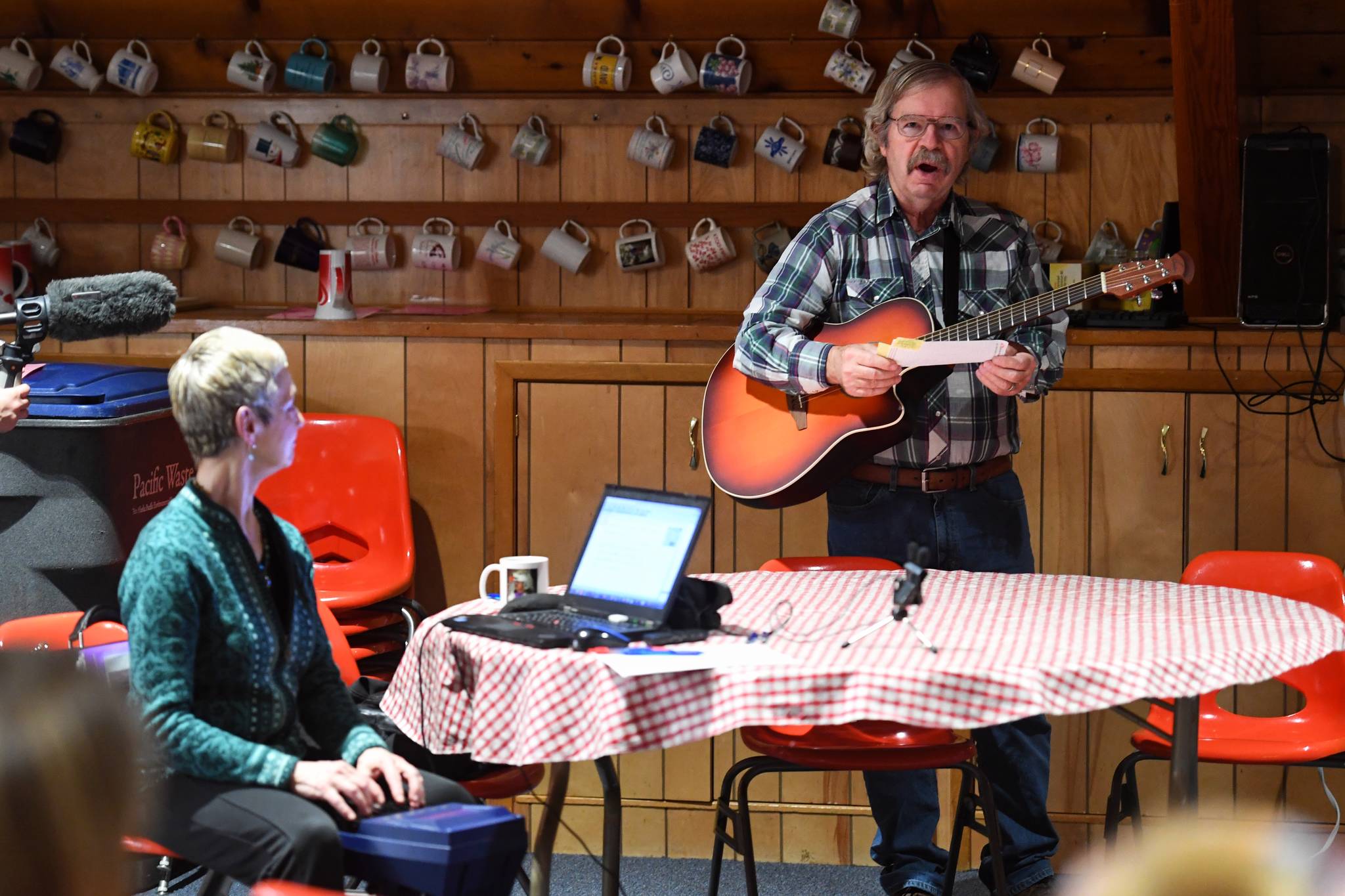 SEACC’s former Executive Director Bart Koehler sings his testimony to oppose the U.S. Forest Service’s lifting of the Roadless Rule as stenographer Lynda Barker records are Northern Light United Church on Dec. 16, 2019. (Michael Penn | Juneau Empire)