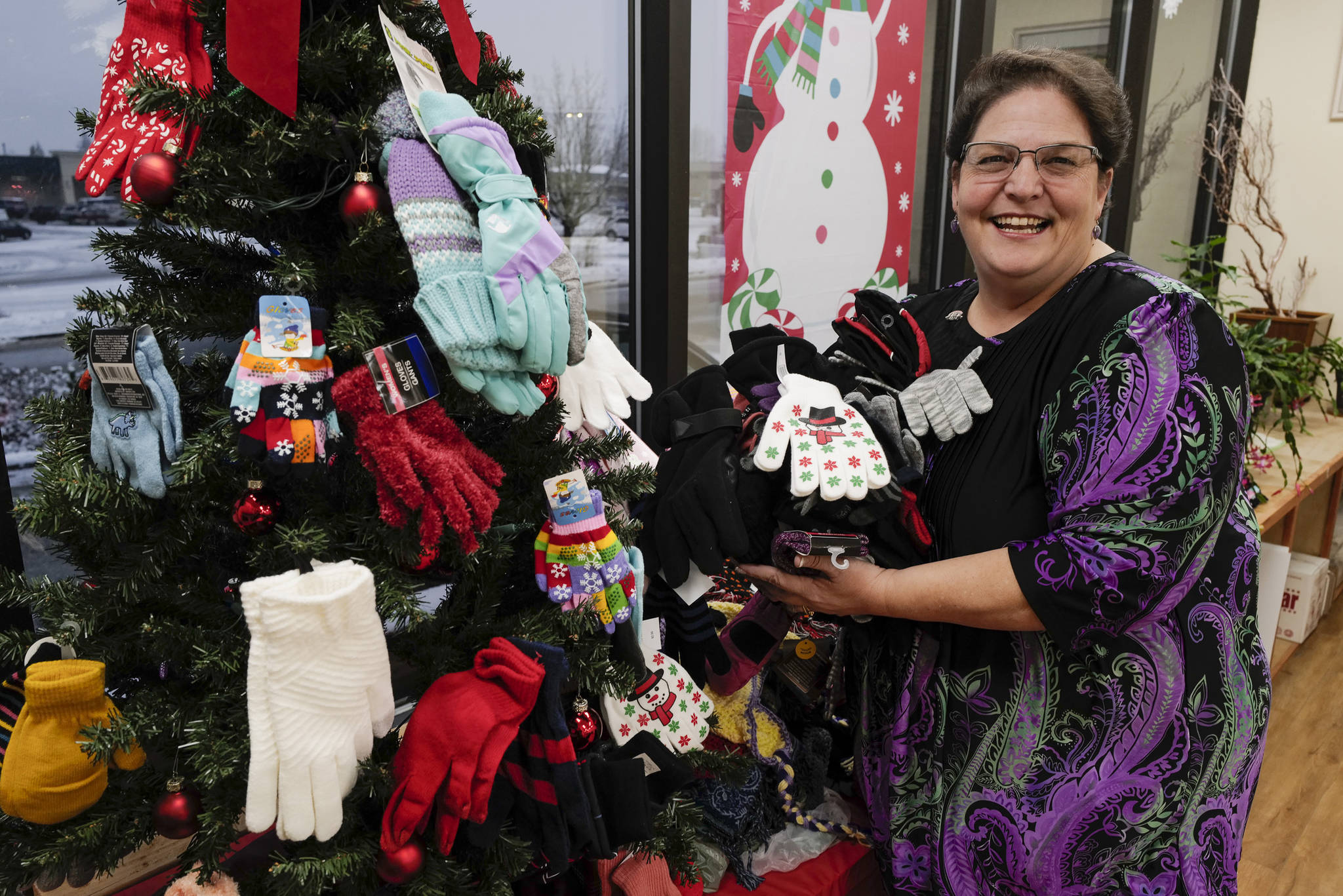 Karen Wright with some of the nearly 700 gloves she has collected on Monday, Dec. 16, 2019. White gives the gloves away to children throughout Southeast Alaska. White was named best realtor in the Juneau Empire’s Reader’s Choice Awards. (Michael Penn | Juneau Empire)