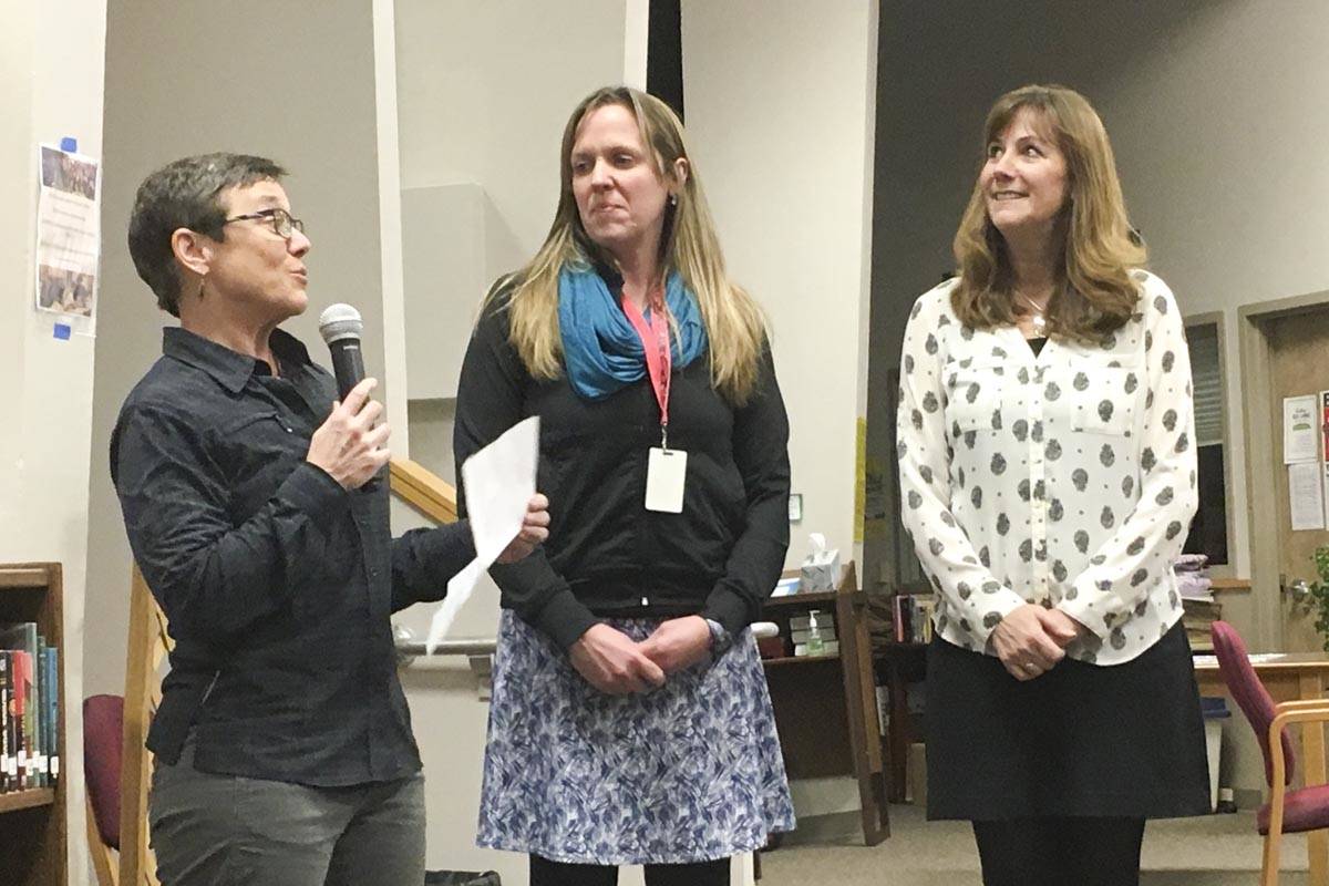Auke Bay Elementary School principal Nancy Peel introduces Angie Wright, center, who received a Presidential Award for Excellence in Math and Science Teaching, alongside Superintendent Dr. Bridget Weiss, during a Juneau School District Board of Education meeting Tuesday, Dec. 17, 2019. (Michael S. Lockett | Juneau Empire)