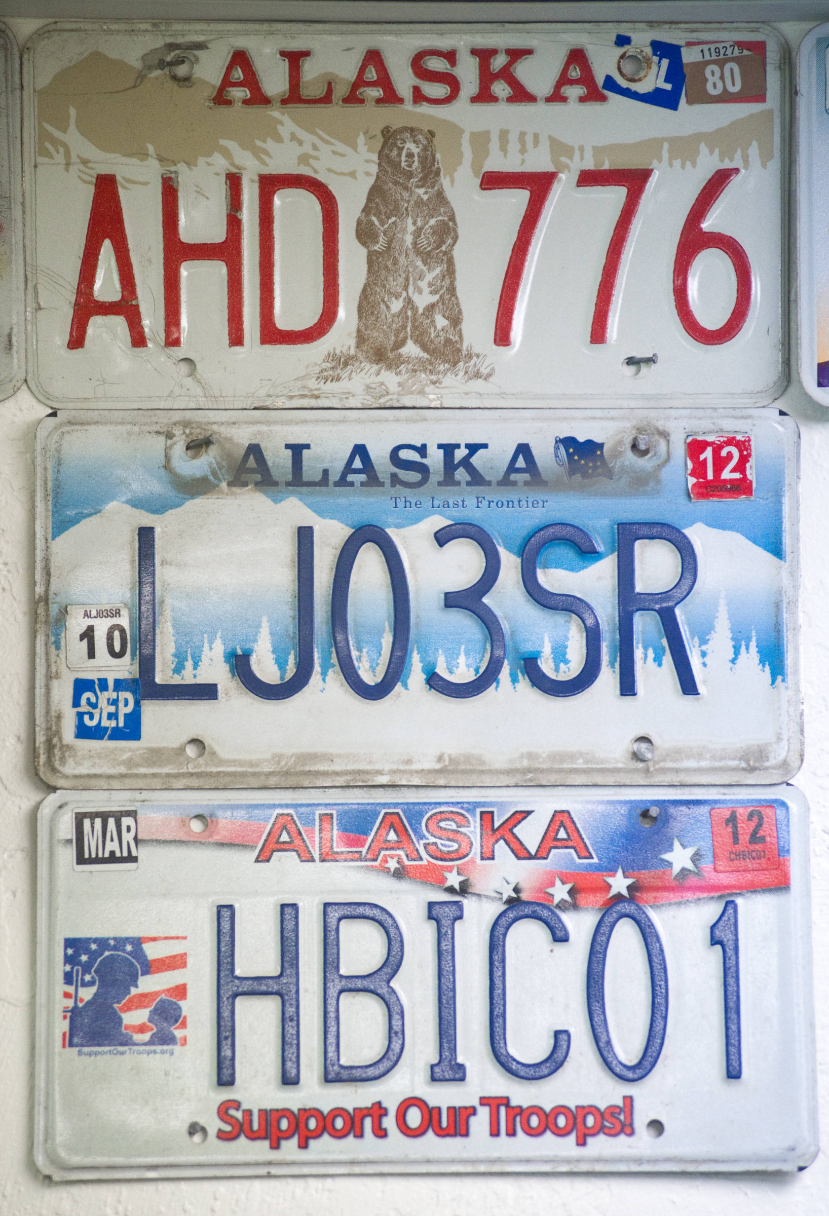 Older custom license plates decorate the wall at the Department of Motor Vehicles in Juneau in this March 2015 photo. (Michael Penn | Juneau Empire File)