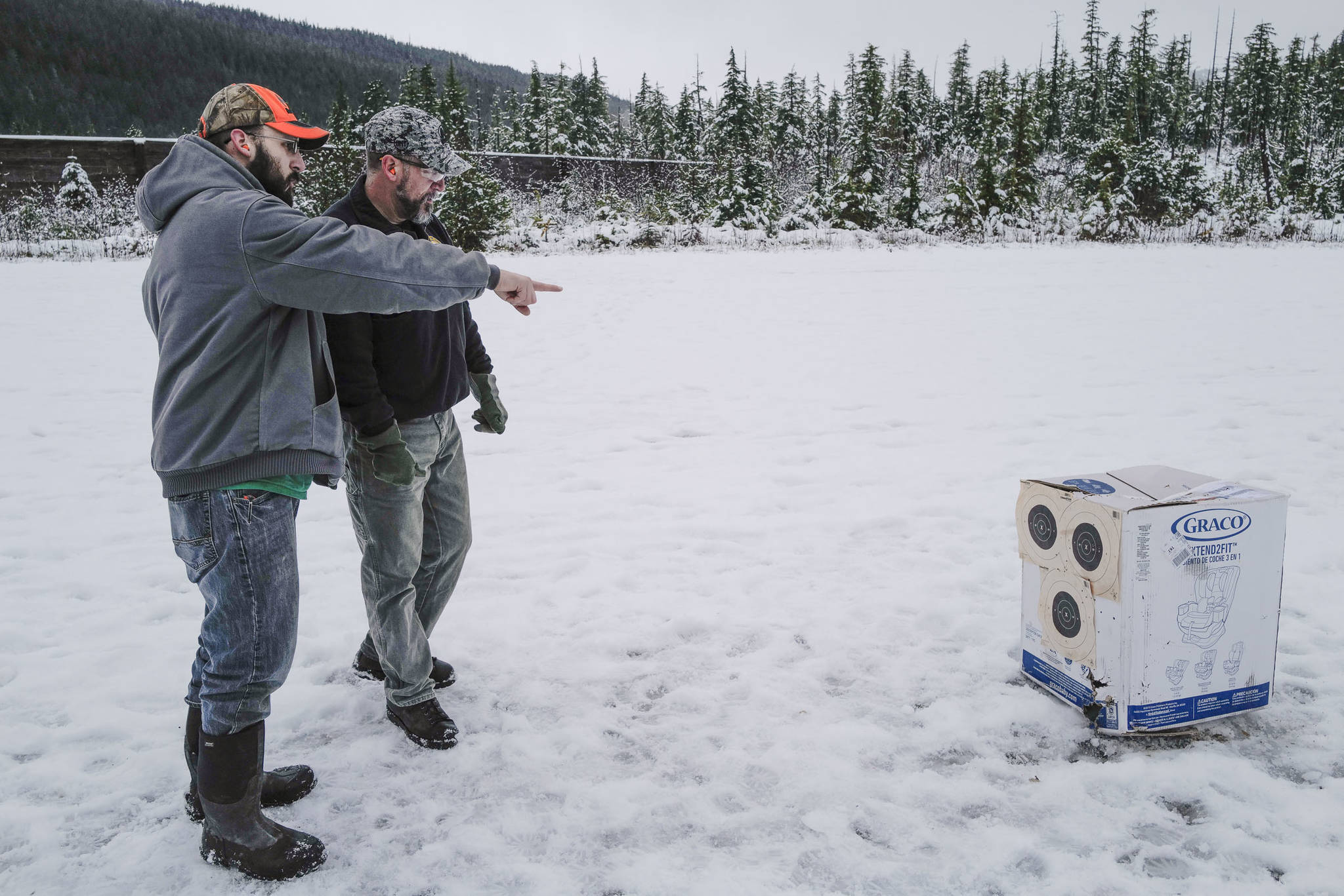 Tim Storbeck Sr., right, and his son, Tim, check on their target while taking target practice at the Hank Harmon Rifle Range on Montana Creek Road on Wednesday, Dec. 18, 2019. (Michael Penn | Juneau Empire)
