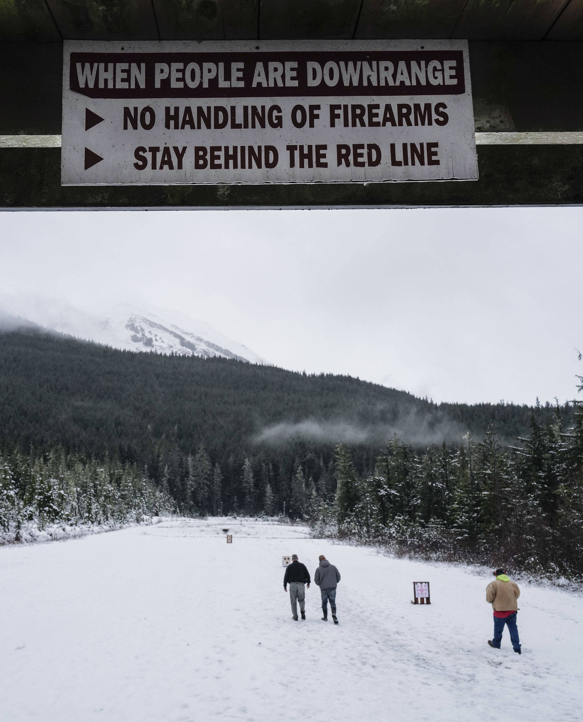 Shooters check on their targets at the Hank Harmon Rifle Range on Montana Creek Road on Wednesday, Dec. 18, 2019. (Michael Penn | Juneau Empire)