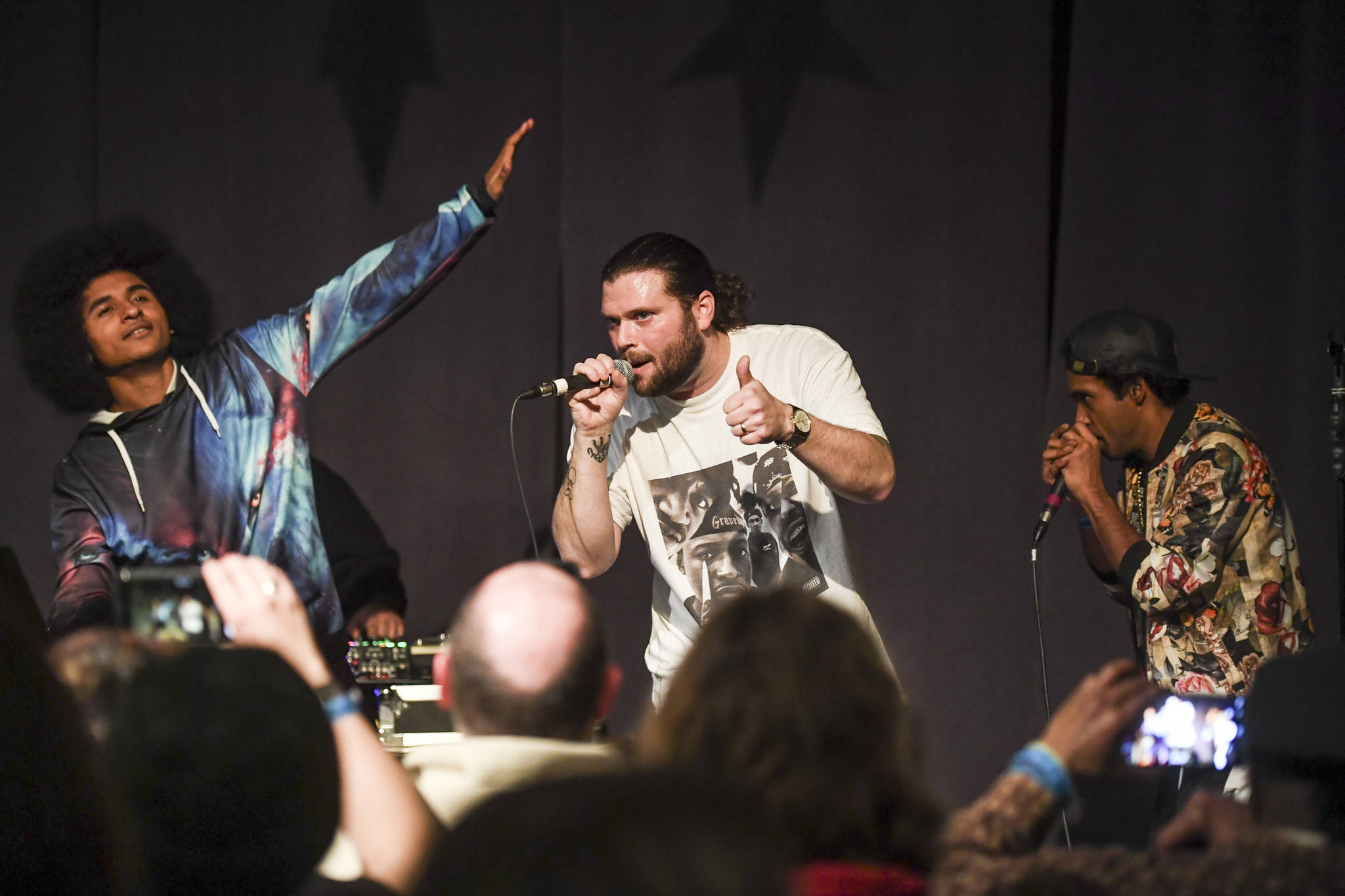 T.J. “Manner” Cramer, center, performs with Arias Hoyle, left, and Chris Talley during the Killah Priest of Wu Tang Southeast Tour at the Juneau Arts & Culture Center on Friday, Dec. 20, 2019. (Michael Penn | Juneau Empire)