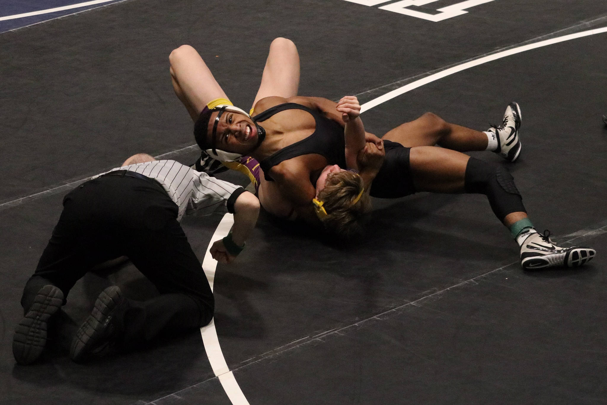 Juneau-Douglas High School senior Jahrease Mays, wrestling for Thunder Mountain, pins Lathrop High School’s Colton Parduhn in the 125-pound semifinals match at the ASAA Division I state meet at the Alaska Airlines Center in Anchorage on Saturday, Dec. 22, 2019. Mays placed second overall in the 125-pound weight class. (Courtesy Photo | Kristie Erickson)