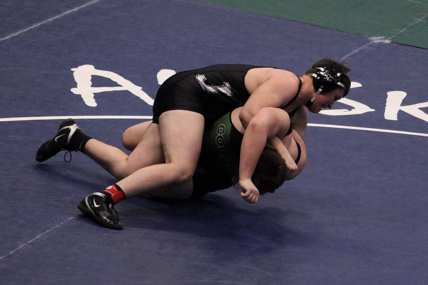 Thunder Mountain High School junior Jake Ferster takes down Colony High School’s Daniel Van Slyke in the 285-pound third-place match at the ASAA Division I state meet at the Alaska Airlines Center in Anchorage on Saturday, Dec. 22, 2019. Ferster defeated Van Slyke by way of a 6-0 decision to take third overall in the 285-pound weight class. (Courtesy Photo | Kristie Erickson)
