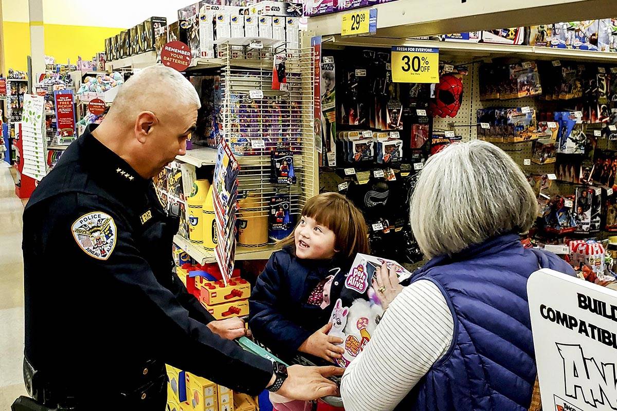 Juneau Police Department Chief Ed Mercer helps a child pick out Christmas presents for their families during the annual Shop with a Cop event, sponsored by the Alaska Peace Officer Association, at Fred Meyer on Dec. 21, 2019. (Courtesy photo | Glenn Ojard)