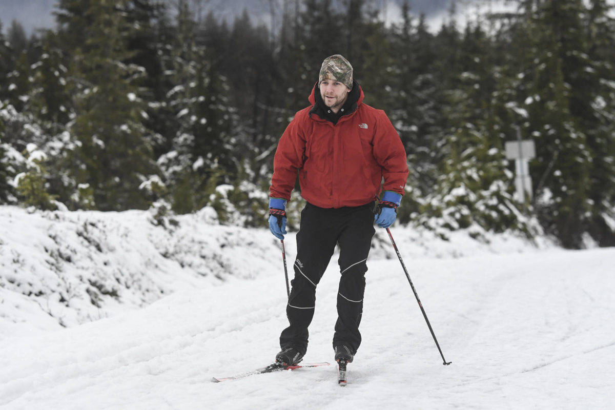 Nick Yankee takes advantage of the remaining snow along Montana Creek Road to ski on Wednesday, Dec. 18, 2019. (Michael Penn | Juneau Empire)
