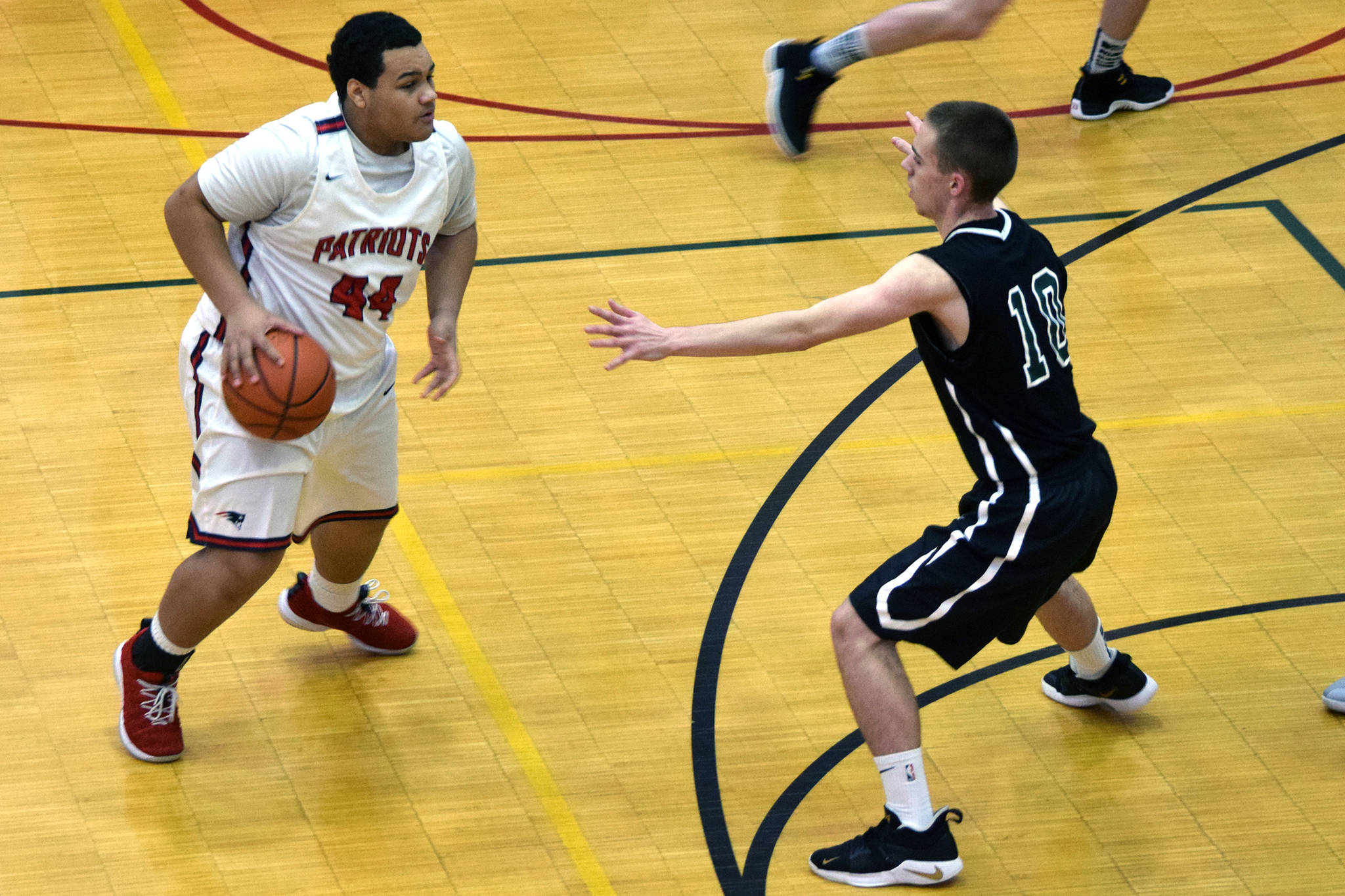 North Pole’s Alijah Agee is defended by Haines’ Carson Crager in their game at the Princess Cruises Capital City Classic at JDHS on Monday, Dec. 30, 2019. (Nolin Ainsworth | Juneau Empire)