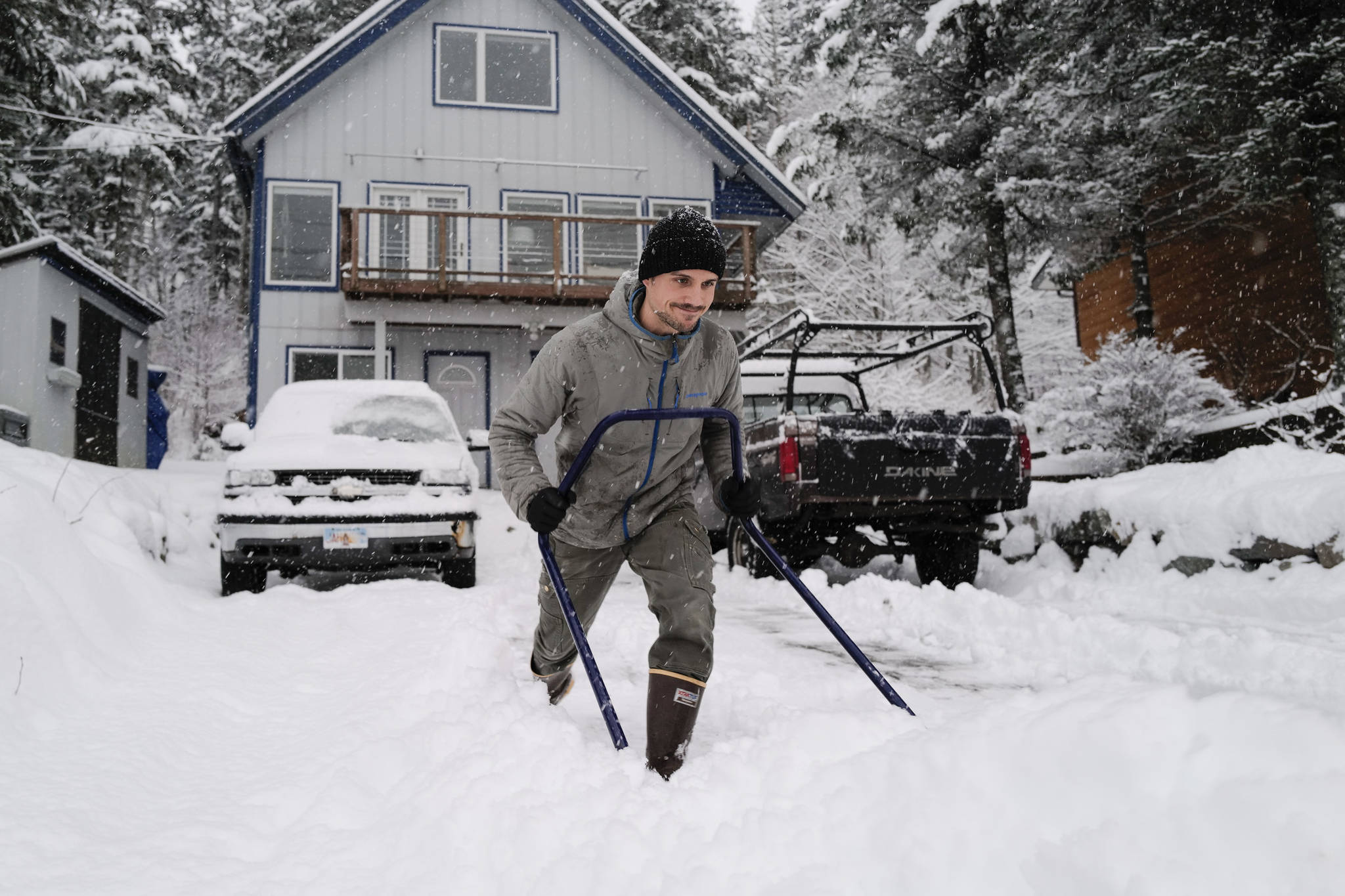 Matt Brooks clears snow out of his driveway along Douglas Highway on Tuesday, Jan. 7, 2020. (Michael Penn | Juneau Empire)