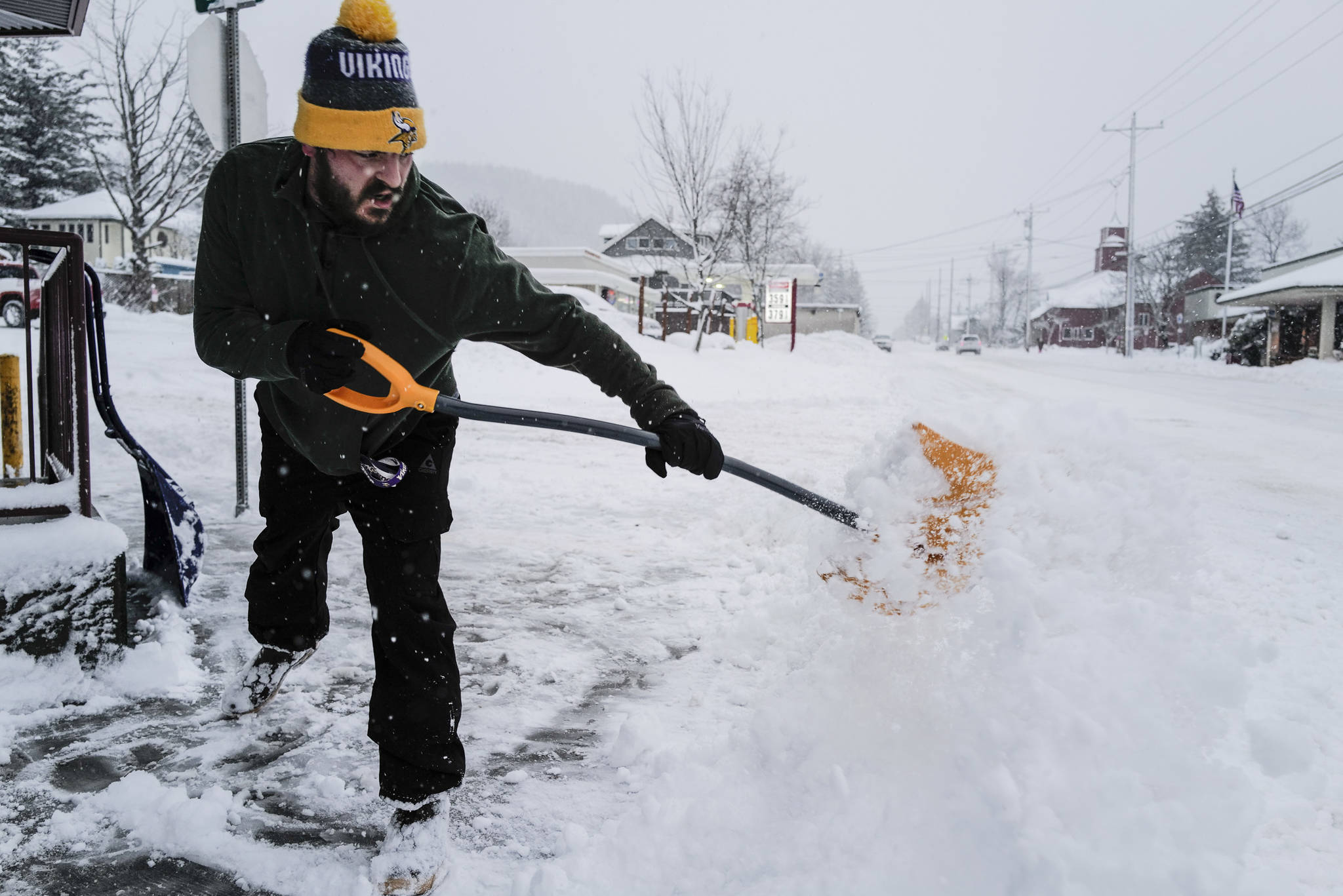 Jeff Thole clears the sidewalk on snow in front of Louie’s Douglas Inn on Tuesday, Jan. 7, 2020. (Michael Penn | Juneau Empire)