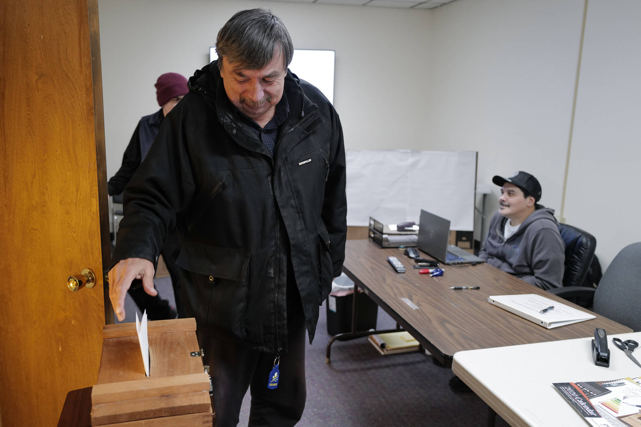 Ron Laiti drops his ballot into a ballot box after voting in the Douglas Indian Association’s election on Wednesday, Jan. 8, 2020. (Michael Penn | Juneau Empire)