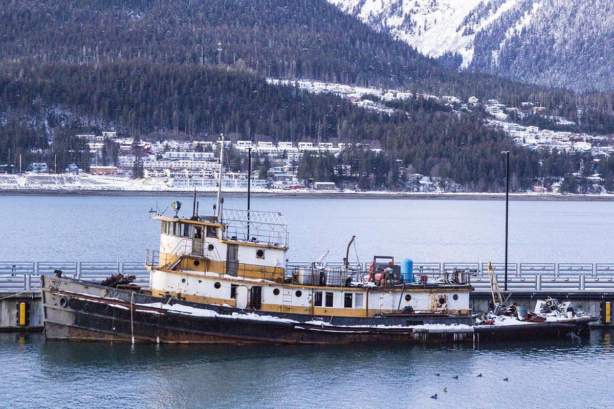 The derelict tugboat Lumberman lies moored to a city-owned pier on Sunday after coming adrift and grounding near Norway Point downtown. (Michael S. Lockett | Juneau Empire)