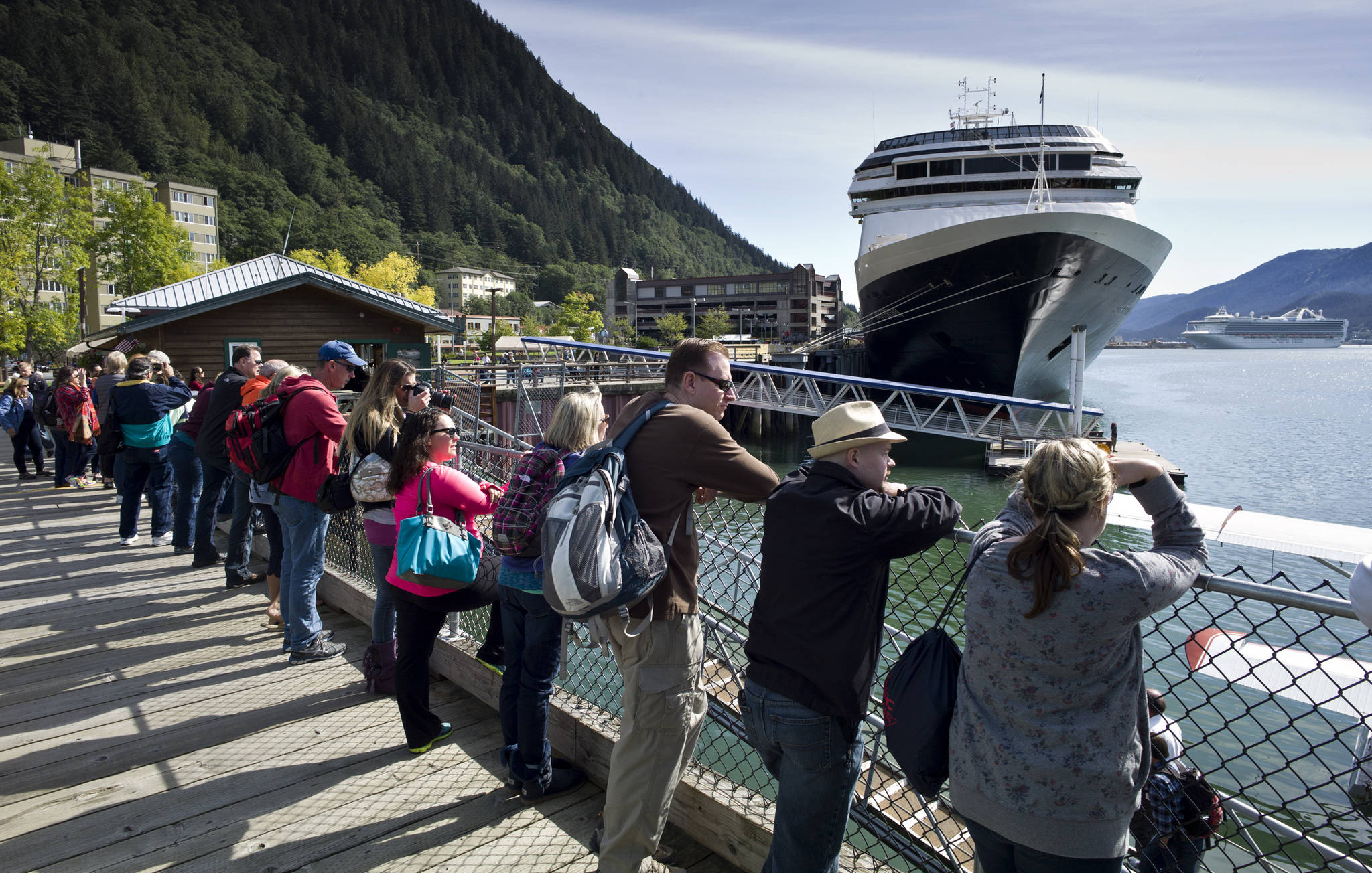 Visitors line up to view Juneaus downtown harbor in August 2015. (Michael Penn | Juneau Empire File)