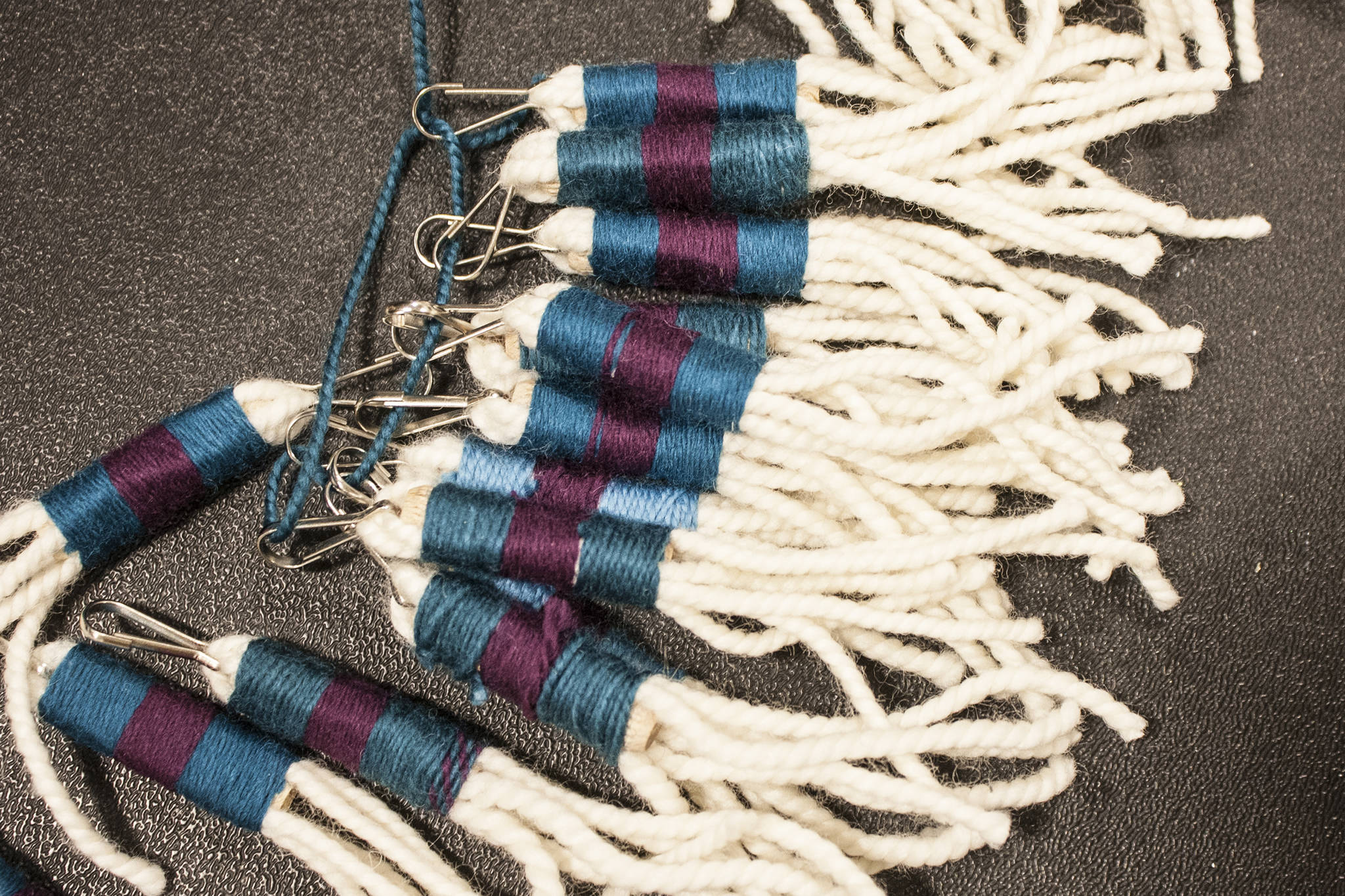 Ben Hohenstatt | Capital City Weekly                                A completed Chilkat tunic fringe zipper pulls lay on a table Sunday at the Tlingit and Haida Community Center.
