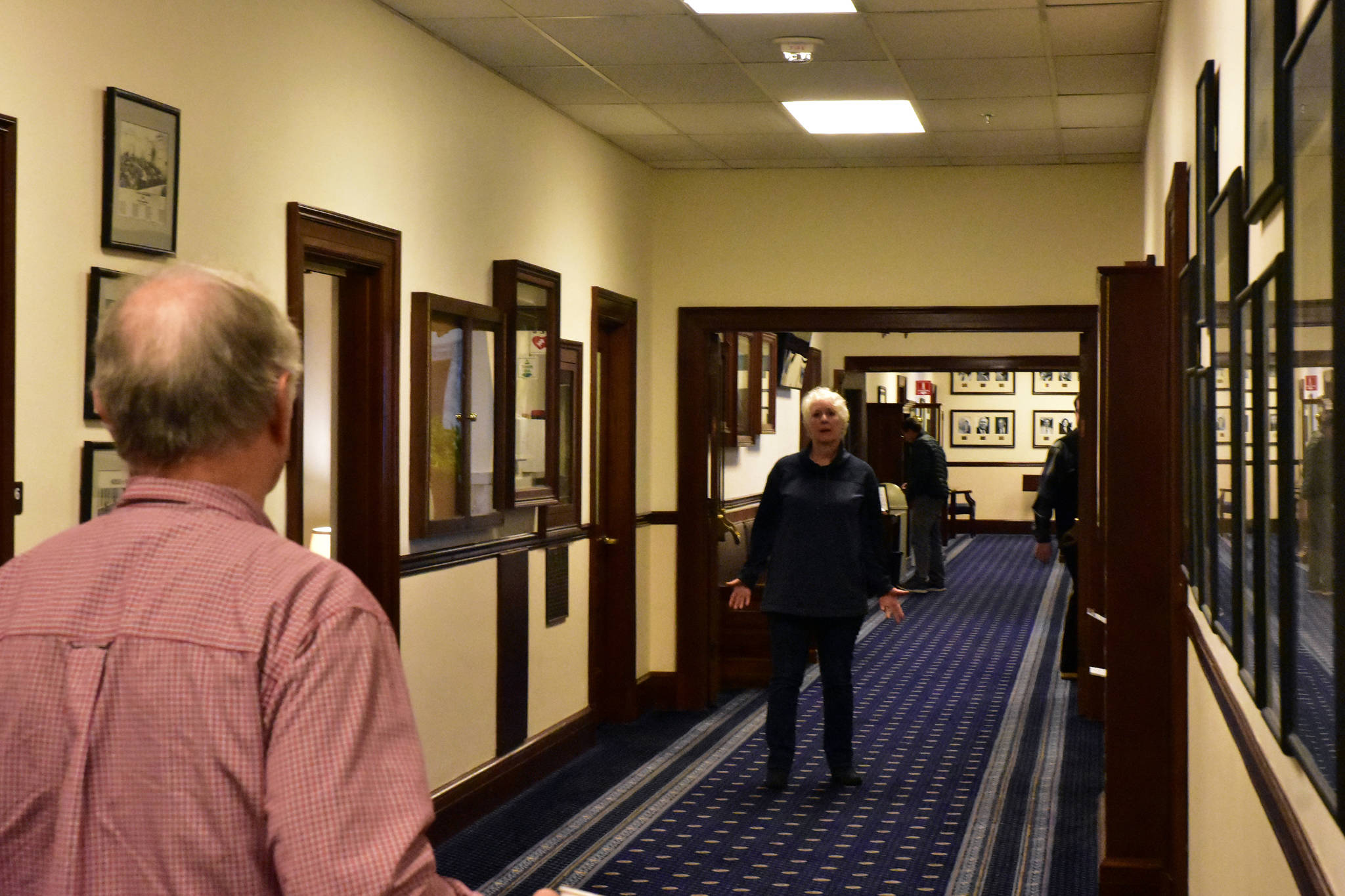 Rep. Louise Stutes, R-Kodiak, chats in the hallway of the Alaska State Capitol on Monday. (Peter Segall | Juneau Empire)