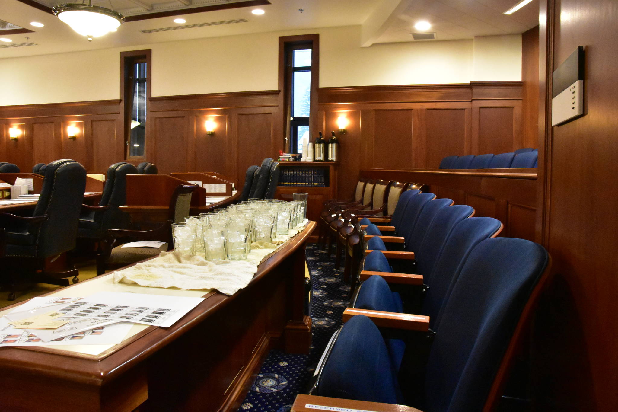 Staff at the Capitol set out extra chairs and water glasses in the House Chambers in preparation for a joint session on Friday, Jan. 24, 2020. (Peter Segall | Juneau Empire)