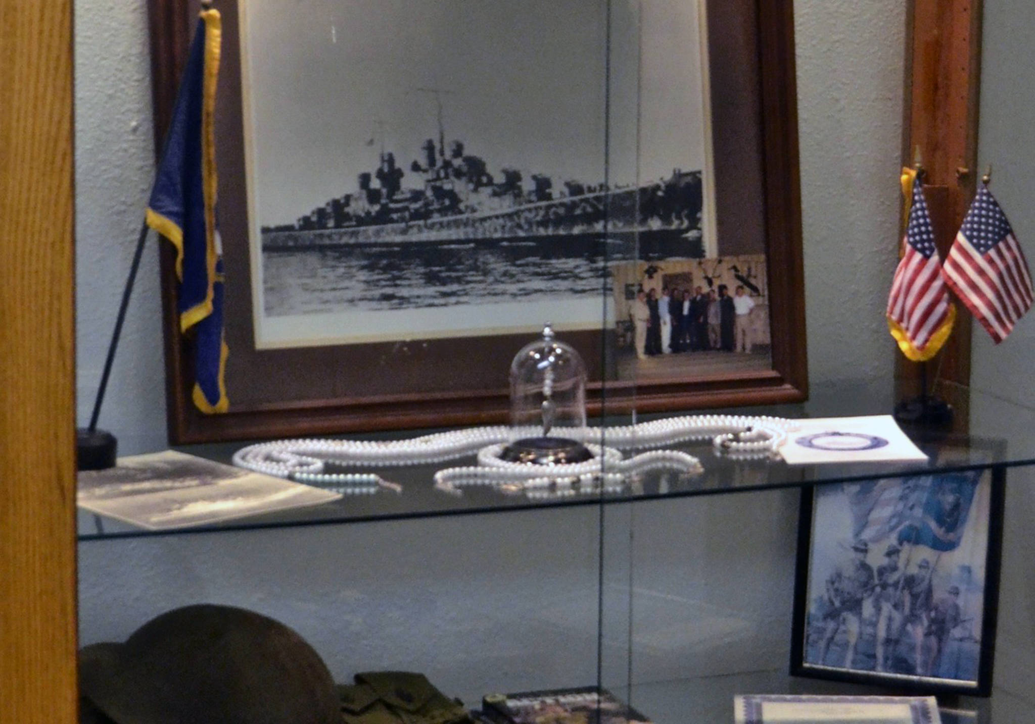 This undated photograph shows the the USS Juneau memorial items that were on display at the American Legion Auke Bay Post #25. The long strand of beads represented those immediately killed during the torpedoing and sinking of the ship, another strand represented those who were alive and in the water, and the short strand represented those who were rescued from the water days later. The final few beads in the glass dome represented those who were still living at the time of the 75th anniversary presentation. (Courtesy photo | American Legion Auke Bay Post #25)