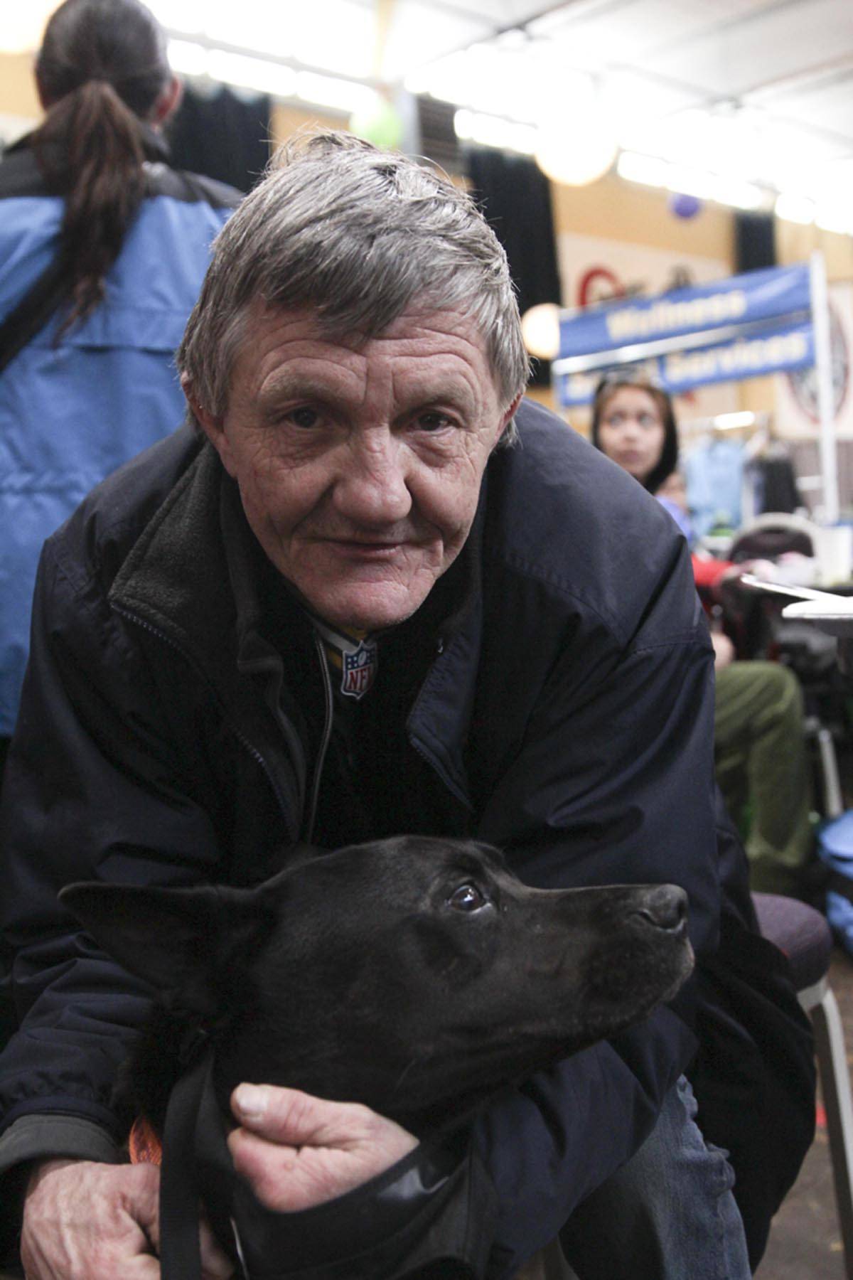 Cary Shilts, a guest, poses with his dog at the Juneau Coalition for Housing and Homelessness’ 9th annual Homeless Connect event at the Juneau Arts and Culture Center, Jan. 29, 2020. (Michael S. Lockett | Juneau Empire)